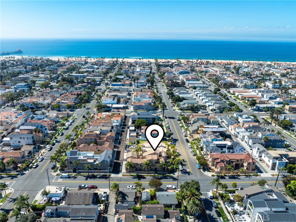 Nestled on one of the quietest, most upgraded, and coveted streets in the heart of Downtown Huntington Beach, this stunning three-level residence is mere steps from the beach, one block from serene Lake Park, and a short stroll to vibrant Main Street, Pacific City, and award-winning schools. A spacious elevated front patio greets you, setting the stage for the bright, airy open floor plan within. The first floor seamlessly connects the living room, two outdoor entertaining areas, family room, kitchen, and dining area, all bathed in natural light. The modern kitchen shines with all-new appliances, a walk-in pantry, and a convenient laundry room. Ascend to the second level to find a generous family room with soaring high ceilings, a luxurious primary suite, and two additional Jack-and-Jill bedrooms, ideal for family or guests. The third level offers a versatile space with a private oversized balcony, perfect for relaxation or entertaining. Blending coastal charm with modern elegance, this home delivers the ultimate Huntington Beach lifestyle in an unparalleled location.