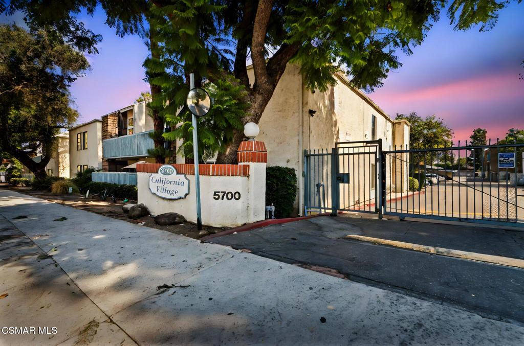 Welcome to this bright, light-filled top floor, 2 bedroom, 1 bath condominium in the sought-after California Village community! This stylish home features a spacious open floor plan featuring a kitchen that opens to a living room with vaulted ceilings and motorized curtains for the upper windows. The primary bedroom offers a walk-in closet. A private balcony provides serene tree-top views, and the unit features a washer and dryer.Community amenities include a pool, jacuzzi, club house, gated entry with overnight security, and two side-by-side parking spaces. HOA dues cover water, trash, weekly complex cleaning, pool/jacuzzi maintenance, tree trimming, and overnight security. Recent building upgrades include a new roof installed in 2024. Conveniently located near Ventura Boulevard dining and shopping, Providence Cedars-Sinai Tarzana Medical Center, parks, and the 101 Freeway.