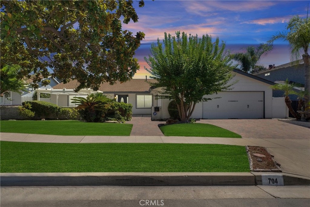 This fabulous, single story, pool Home on tree lined cul de sac has it all. Upgraded, move in ready, open, light and bright. A perfect blend of comfort and elegance, this home has so much to offer. Starting with the huge formal living room with extra large picture window and formal dining room, providing plenty of space to entertain in style. Remodeled kitchen with an abundance of shaker style wood cabinets with pull out shelves, granite counter tops provide all the counter space you could want, all new stainless appliances, recessed lighting and gorgeous garden window overlooking beautiful Lanai and pool. Family room off kitchen has inviting fireplace and slider to Lanai for indoor outdoor living. Family room has been expanded into (previous) bedroom #4 (easily add a wall and closet for 4th bedroom). Spacious primary suite with ample closet space, en suite bath and slider with pool view. The 2nd and 3rd bedrooms are very nice size. Hall bath remodeled with new tub/shower tile surround, vanity, quartz counter tops, fixtures, mirror and tile floors. Home has beautiful engineered hard wood floors, new carpet in primary and 2nd bedroom, freshly painted throughout, dual pane windows, new ceiling fans, new plugs and switches. Beautiful panel doors including closets, led recessed lighting, central heat and air, separate indoor laundry room and walk in pantry. Outside is a show stopper with fabulous covered lanai, overlooking gorgeous pool with water feature and Baja shelf. Backyard pavers add to the beauty and easy upkeep. Landscaping is outstanding and yard if very private. There is also a huge front patio, pavers on driveway and a 2.5 car garage (one side has a pull through - great for small boat, wave runners or ???) and lots of cabinets and work space. This is the perfect place to vacation at home of have huge gatherings. Wonderful location, friendly -"Leave it to Beaver" type neighborhood. Don't miss out on this one!