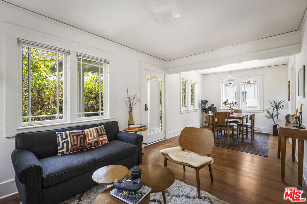 In the heart of Atwater Village, this delightful 2+1 California bungalow with a separate accessory 1+1 building combines vintage charm with options for homeowners eager to settle in this sought-after neighborhood. The separate 1+1 is permitted as a playroom with bathroom, but you can use as a guest suite or a productive workspace - the opportunities are endless. With a premium location and spacious flat lot, the property is perfect for expansion, renovation, or turning the studio into a cozy ADU. Freshly painted interiors highlight the original details retained: wide plank hardwood floors, vintage windows, and built-in cabinetry. The kitchen boasts a newly installed butcher block countertop, a nod to modern practicality without sacrificing charm. The lush grounds feature a flat lot of 6746 SF and an orchard of possibilities - avocado, fig, lemon, orange, peach, and apple trees. Spacious 2-car garage offers off-street parking and workshop potential. Concrete and tile patios offer spots for quiet reflection. Atwater Village offers so many vibrant and stylish shops and eateries, including McCalls, Spina, Sinizki, DeKor, Homestate, and Proof - too many to mention in this NELA cultural epicenter.