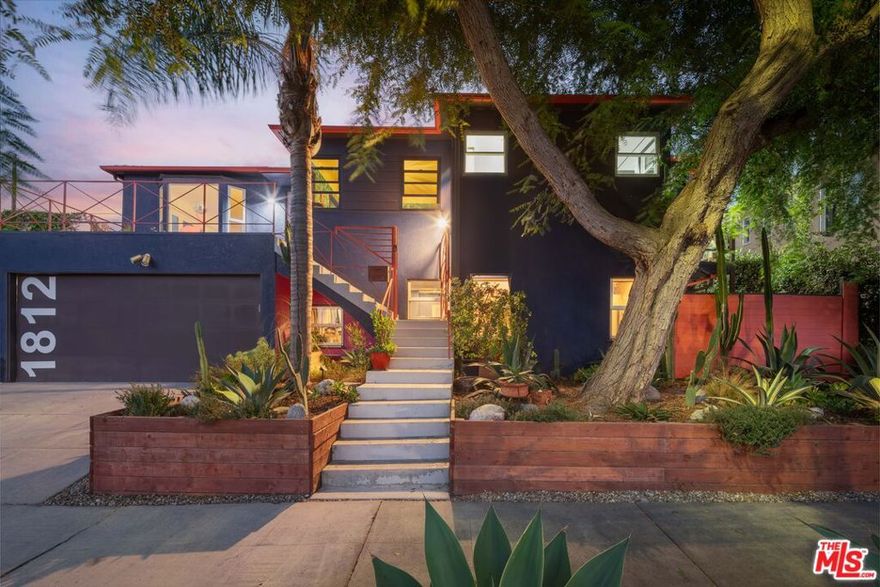 Hidden at the end of a quiet Mid-City cul-de-sac, 1812 S. Dunsmuir feels like an artist's retreat in the middle of Los Angeles. This cobalt-blue sanctuary offers 3 bedrooms, 4 baths, and over 2,300 square feet of effortlessly eclectic living where creativity, comfort, and design converge. Natural light fills the main level's airy living room, complete with high ceilings, fireplace, and city views that stretch into the distance. The eclectic dining room radiates sophistication, flowing into a remodeled kitchen with stainless steel cabinetry, new Smeg 5 burner Range with modern appliances and thoughtful details showcasing a love for cooking. Completing the upper floor are two en-suite bedrooms each framed with Shoji closet doors which provide serene symmetry, joined by a moody powder room with vintage inspired clawfoot tub and beautiful art deco wall paper. Downstairs, the expansive primary suite feels like your own hideaway, bold, bohemian, and tranquil with Moroccan-inspired textures and direct access from the garage. Outdoors, the property truly shines: dine beneath string lights on the private patio, unwind in the new jacuzzi under the stars, harvest herbs from your garden, or work in the most charming bonus office/workout space you'll ever see. And yes, on a clear night, you can even spot the Hollywood sign. Complete with new roof, flooring, jacuzzi, tankless water heater, HVAC and more, this home offers both style and substance. Located minutes from Culver City, the Westside, DTLA, and the beach, this home delivers the Eastside vibe you love, right in the heart of LA.