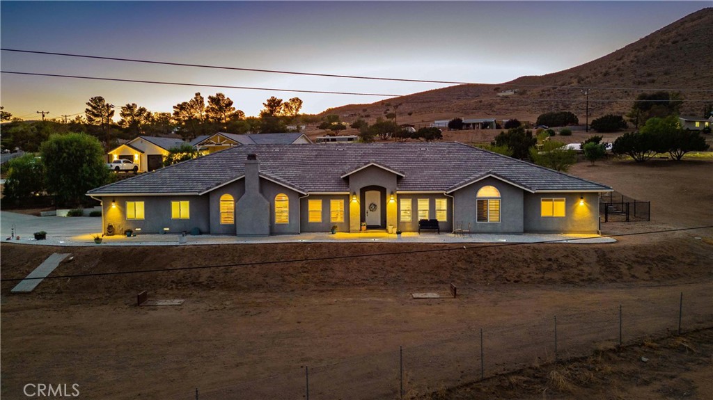 BUYER INCENTIVE - $25,000 for CLOSING COSTS or RATE BUY-DOWN! Custom Single Story Luxury Home with sweeping mountain views and wide-open spaces! Welcome to this 4-bedroom Entertainer’s Home in the sought-out neighborhood of Crescent Ranch, a quiet, cul-de-sac location on 1¼ Acres, ideal for horse facilities, an ADU or RV Garage. Great layout with a blend of designated and open space: entertain in the formal dining and living rooms, host gatherings in the kitchen or cozy-up in front of the fire in the family room. The elegant kitchen is the heart of the home with Stainless Appliances, Quartz Counters, Cherry Cabinets and discrete laundry room and walk-in pantry. Adjacent Family Room will captivate guests with shared focal points of window-boasting views and the stately fireplace. The home has 4 spacious bedrooms, but the Primary Bedroom is a retreat, with private access to the backyard, bathroom with dual sinks, gorgeous walk-in shower and jetted tub, plus a walk-in closet. Upgraded features throughout will impress the most discerning eye: 6” crown molding and baseboards, high, coffered ceilings, ceiling fans, tile and luxury vinyl flooring, new paint, wide hallways and a bonus/storage room. Indulge yourself in the resort style backyard, outfitted with a covered patio, complete with ceiling fans and lighting, Swim-Spa, drought tolerant landscaping and fenced area, ideal for a green house, playground or kennel. Toy enthusiasts will appreciate the immaculate 4-Car Garage with storage cabinets, epoxy floors, workshop area and additional gated RV parking adjacent to the house. The property is fully fenced with an automated security gate in the driveway. This home is a must-see, close to schools, shopping and restaurants, with county water, natural gas, paved roads and easy freeway access. Come home to luxury living in the country!