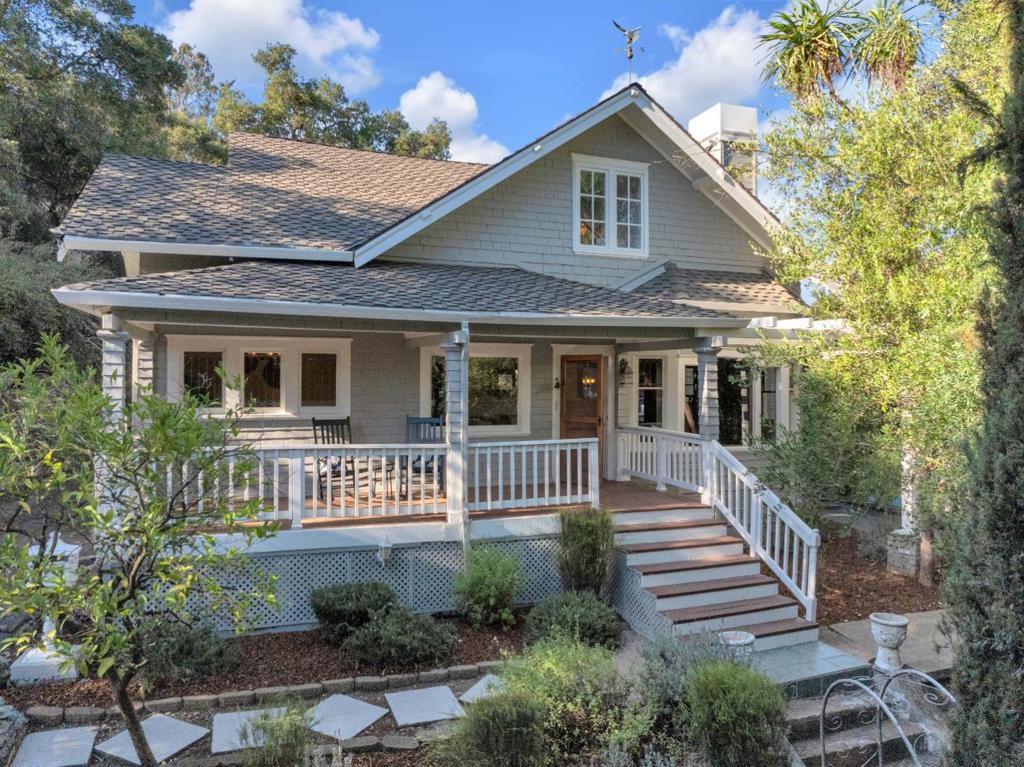 A timeless Craftsman masterpiece nestled on a sprawling over 1/2 acre lot with breathtaking views, just steps from vibrant downtown Morgan Hill. This exceptional home is the perfect blend of classic character, modern comfort, and a truly unbeatable location. The entertainers dream outdoor kitchen and elevated deck overlook rolling hills and sparkling city lights, creating a private resort experience complete with a two-tier black concrete bar, dual refrigerators, kegerator, range, undermount sink, and two Bromic Tungsten Smart Heaters for year-round enjoyment. An awe-inspiring front porch leads inside to rich hardwood floors, crown molding, and custom wainscoting that highlight the stunning living room and executive office framed by tapered columns and a wood beam. The formal dining room features an original pocket door, built-in buffet, and a beautiful chandelier. Two downstairs bedrooms include fully remodeled ensuite baths with designer tile and frameless glass showers. Upstairs, dual primary suites each offer their own distinctive character. One with an oversized farmhouse door, dual closets, fireplace, and modern shower with skylight views; the other with warm wood detail, soaking tub, and dual vanities. Timeless elegance meets modern living in this extraordinary estate.
