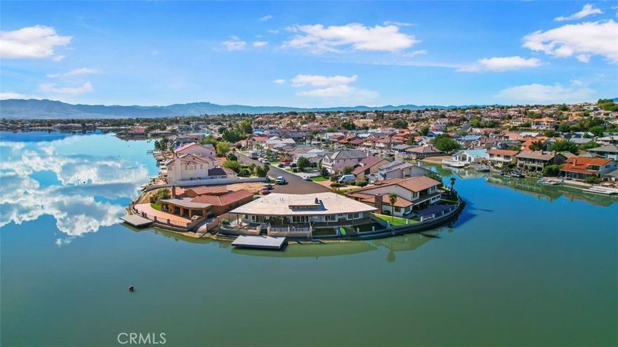 Location! Location! Location! Open water! Tranquil single story 4 bedroom, 3 bathroom home that is located on the open water of highly desirable Spring Valley Lake. This home has it all. One of the most desirable lots in SVL, sun and wind protected , open water, at the end of a cul-de-sac , large fixed dock, boat ramp, low maintenance yard with slate tile and synthetic turf. Pie shaped large lot that has twice the waterfront of a typical waterfront lot. Large bedrooms, walk-in closet, numerous glass doors open up to large covered patio, beautiful hardwood and tile floors, amazing fireplace, wet bar, stainless appliances, central a/c and heat, laundry room with numerous pantry cabinets and built in sink, finished 2 car garage with built in cabinets, modern smooth roll up door with opener. Park, golf, country club, restaurants, post office, market, marina, gas station, equestrian center all nearby. Perfect home for retreat, summer home or entertaining.