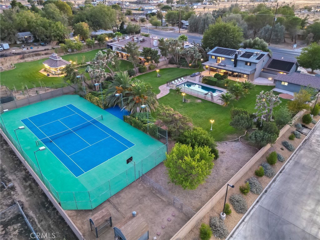 ***CUSTOM RANCH STYLE HOME*** Subject property offers 6 ample bedrooms, which includes a game room, an office/den, and an exercise room, on a 3,773 Sq Ft of living space, sitting on a 1.064-acre LOT, with its very own 5,000 Sq Ft private TENNIS COURT, and a fenced LAP/EXECERSICE POOL. Last but not least, the ample detached 2 car garage has its own private entrance, and its own electrical panel box, ideal for an ADU conversion. As you make your way inside you will be greeted by a gorgeous, and elegant chandelier, beautiful custom tile wood flooring, and an elegant French door. The kitchen offers custom tile wood flooring, elegant quartz counter tops, white cabinetry, two pantries, and an amazing view of the custom, manicured backyard. The family room offers a custom fireplace, and a custom wet bar with its built-in wine cooler, perfect for entertainment. The dining area offers an elegant chandelier, custom tile wood flooring, and a gorgeous view of the water fountain. The living room offers a custom fireplace, custom wrought iron rail, and beautiful custom tile wood flooring as well. The stairs, and second floor hallway also offer a custom wrought iron rail, and tile wood flooring. The primary bedroom offers its very own balcony with custom tile, and a wrought iron rail, with a perfect view of the manicured backyard, and city lights. The primary bathroom offers a custom, and ample walk-in shower, granite counter tops, a vanity area, a walk-in closet, and a separate toilet room. The rest of the bedrooms offer new ceiling fans, and tile wood flooring. The custom bathrooms also offer tile wood flooring, and ample walk-in showers. As you make your way to the backyard you will find plenty of fruit trees (pomegranate, apricots, apples), and beautiful palm trees, giving that tropical vibe. The covered patio offers custom tile flooring, a custom BBQ, and a custom wrought iron BAR, perfect for all your summer family gatherings. The lap/exercise pool offers a diving board, a slide, and fully fenced by a wrought iron gate, should you have any little ones. The private tennis court offers, Vinyl-Coated Chain-Link Fencing, and 8 OUTDOOR TENNIS COURT LIGHTS. Best part of all, this home sweet home is conveniently located minutes away from all amenities including COSTCO, KAISER Permanente, recreational parks, shopping centers, restaurants, and easy access to the north, and south freeway.