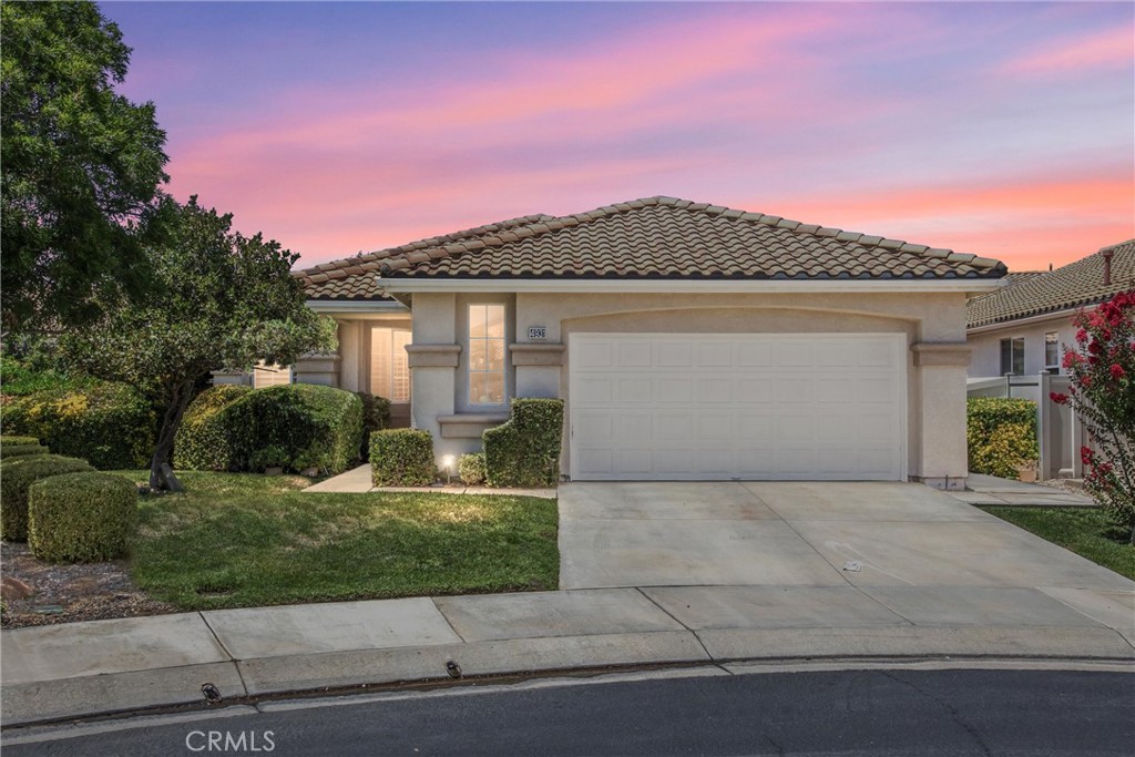 Popular Forsynthia model located on a quiet cul-de-sac in the desirable, guard-gated Sun Lakes Country Club. This meticulously maintained 2 bed + den, 2 bath home offers 1,683 sq. ft. of comfortable living space. The den is perfect for a Murphy bed or hide-a-bed, making it ideal for guests. Beautiful white tile flooring in main areas, with carpet in bedrooms, den, and living area. Kitchen and laundry room feature upgraded tile flooring; kitchen boasts granite countertops. Spacious great room with gas fireplace is open to the dining area and kitchen, offering abundant natural light. Ceiling fans in living room and primary bedroom. Sliding glass doors lead to a large covered patio and a beautifully landscaped side yard with apple, cherry, and apricot trees, plus vibrant rose bushes. Patio furniture included. Appliances—stove, refrigerator, microwave, washer, and dryer—are included. Enjoy resort-style living with two 18-hole golf courses, 3 clubhouses, restaurants, indoor & outdoor pools, tennis, pickleball, fitness centers, and countless clubs and activities. Age-qualified 55+ community with 24-hour security. Incredible value under $500,000! IF YOU'RE LUCKY ENOUGH TO LIVE IN SUN LAKES - YOU'RE LUCKY ENOUGH!!!