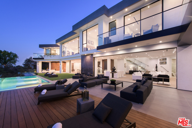 This one of a kind brand new construction, warm contemporary residence is an achievement of style and design. Located in a premier location of Brentwood, this home offers extraordinary unobstructed views from the San Gabriel Mountains to Downtown LA to the Ocean. Beyond the home's massive front pivot door, find soaring ceilings, open floor plan & floor to ceiling windows which provides an abundance of natural light throughout. With approx. This home is made for entertaining. Featuring a chef's kitchen, open living & family room, contemporary finishes, big-screen theater, wine cellar and bar. The master suite reveals a sleek indoor-outdoor bathroom boasting an oversized shower, dual vanities, freestanding bath tub all with sensational city views & a beautiful walk in closet. Fleetwood pocket doors seamlessly open to the backyard where you'll find a zero-edge pool, spa, and BBQ. This is one of the most spectacular properties to come to the market in Brentwood.