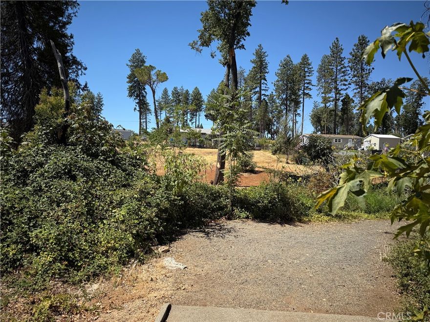 Discover the possibilities on this spacious .23-acre lot tucked along peaceful Travis Road in Paradise. Surrounded by trees and set in a quiet residential neighborhood, this parcel offers a level building area with easy access to town, schools, and local parks. Whether you're ready to build now or planning for the future, this lot provides a welcoming blend of privacy and convenience. With paved road frontage and utilities nearby, it's a prime spot to create something lasting in the foothills.