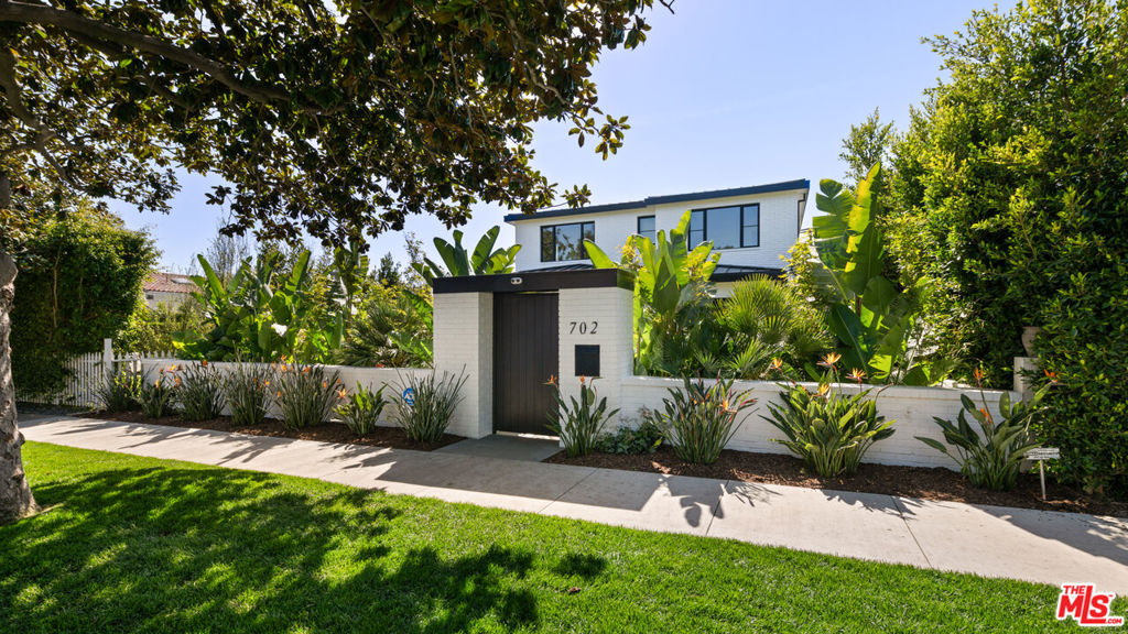 Located in the coveted North of Montana neighborhood in Santa Monica, this custom-built residence is a true work of art, crafted with the utmost attention to detail. Featuring a harmonious blend of sleek lines and a practical layout, this home seamlessly combines sophistication, privacy, and an abundance of natural light. Spanning 6,400 square feet, the residence offers 5 bedrooms and 7 bathrooms, with expansive floor-to-ceiling windows and doors that create an airy, open ambiance throughout the home. The exterior's timeless brick facade is complemented by lush, mature landscaping, offering a serene and private sanctuary. The open-concept living area boasts 12-foot ceilings and floor-to-ceiling doors, effortlessly connecting the interior with the outdoor oasis, which includes a sparkling pool. The gourmet kitchen and bathrooms showcase exquisite marble countertops and sleek custom Italian cabinetry, while elegant touches such as recessed lighting, custom built-ins, and natural stone surfaces enhance the space. A standout feature of the home is the central staircase, framed by a stunning wall of windows and a beautiful skylight, bathing the entire space in natural light. The primary suite offers a serene retreat, complete with a spacious balcony, large walk-in closet, and a spa-inspired bathroom which overlooks the pool. The upper level also features two additional bedrooms and a generously sized laundry room with a dedicated steam dryer closet. The lower level is designed for both relaxation and entertainment, offering a large bonus space, an expansive gym, an additional laundry room, and a guest suite. Additional highlights include a whole-house Eversoft water filtration and softening system, along with an IQ Air purifier on all AC units for clean air and water. Solar panels with battery storage, as well as a comprehensive security system, provide peace of mind and energy efficiency. This home is fully equipped with a smart home system, including a Lutron system for controlling lighting and automatic shades on every window, as well as a speaker system throughout the property. With bespoke finishes, this extraordinary residence merges modern amenities with timeless elegance, offering the ultimate in luxury living.