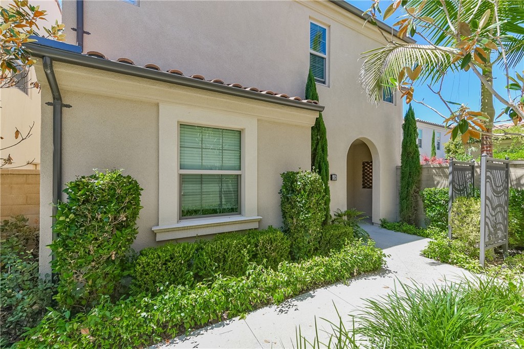 Welcome to this stunning home, offering the perfect blend of luxury and functionality. This beautiful residence features 4 spacious bedrooms and 3.5 elegant bathrooms, including a convenient downstairs suite ideal for guests or multi-generational living. Interior Highlights: Expansive Layout: The open floor plan is designed to maximize natural light, featuring double-height ceilings, dual-pane windows, and bi-fold doors that seamlessly blend indoor and outdoor living spaces. Gourmet Kitchen: The kitchen is a chef's dream, equipped with sleek white shaker cabinets, state-of-the-art Bosch stainless steel appliances, and luxurious Caesarstone countertops, all flowing into the enormous Great Room perfect for entertaining. Master Suite: Retreat to the expansive Master Suite, complete with a large walk-in closet and a luxurious en-suite bathroom featuring a soaking tub and a separate shower. Secondary Bedrooms: Two additional bedrooms are connected by a well-appointed Jack and Jill bathroom, offering dual vanities and a shower-in-tub combo. Versatile Loft: An open loft space provides flexibility for a home office, media room, or play area. Exterior & Additional Features: Private Back Patio: The easy-to-maintain back patio is your private oasis, with side gate access for added convenience. Garage Access: A two-car garage provides direct access to the home, enhancing convenience and security. Modern Upgrades: The home has a state-of-the-art tankless water heater, energy-efficient LED recessed lighting, Solatube lighting system, and a high-performance HVAC system to help keep utility costs low. Community & Location: Cypress Village Amenities: Enjoy resort-style amenities, including a pool, spa, play area, park, and clubhouse, all within the Cypress Village community. Prime Location: Ideally situated near the 5 freeway, Woodbury shopping center, Great Park and toll roads, offering easy access to shopping, dining, and entertainment. Top Schools: Served by the acclaimed Irvine Unified School District.
