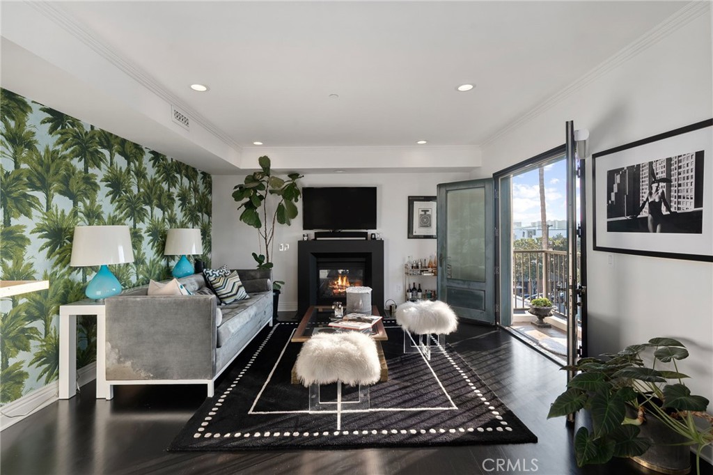 Experience the Essence of West Hollywood Living. Step into a dream PENTHOUSE retreat where style meets sophistication. Perched on the top level of the glamorous building, this light-filled, SINGLE-LEVEL, front-facing residence on the 4th floor offers unmatched privacy with only one shared wall and panoramic views. Just moments from the allure of Melrose Place, you’ll find yourself surrounded by high-fashion boutiques, the vibrant Sunday Farmers Market, quaint cafes and the city's most iconic destinations. The building itself radiates classic Hollywood charm, blending timeless elegance with modern safety and serenity. Inside, a spacious living area welcomes you with walls of light streaming through French doors, opening to balconies showcasing breathtaking vistas of sparkling city lights and the iconic Hollywood Hills—a view as enchanting as the city it embraces. The kitchen is a true chef’s delight, boasting top-of-the-line appliances that combine both form, function with a view of the city. A dedicated dining area perfectly complements the culinary space, setting the stage for unforgettable gatherings. When the celebrations wind down, retreat to the expansive master bedroom, a sanctuary of comfort and calm, complete with a luxurious ensuite bathroom designed for ultimate relaxation. Two additional bedrooms provide ample room for family or guests, each offering its own blend of warmth and privacy. For added convenience, this residence features an individual laundry room with a brand-new washer and dryer—adding a touch of practicality to this luxurious home. Convenience meets exclusivity with two private, secure parking spots in a subterranean garage, and a secure elevator that takes you directly to the penthouse on the 4th level for ultimate ease and privacy. Generous guest parking ensures visitors always feel welcome. Best of all, the building’s private rooftop garden—on the same level as the penthouse—is a serene oasis. Complete with gorgeous chaise lounges, this open-air retreat invites you to bask in the sun, unwind in comfort, or savor the brilliance of sunsets over the Hollywood skyline. This penthouse is more than a home; it’s a lifestyle—a light-filled haven that’s a must-see for those young at heart and a must-have for those who embrace life with discerning enthusiasm.