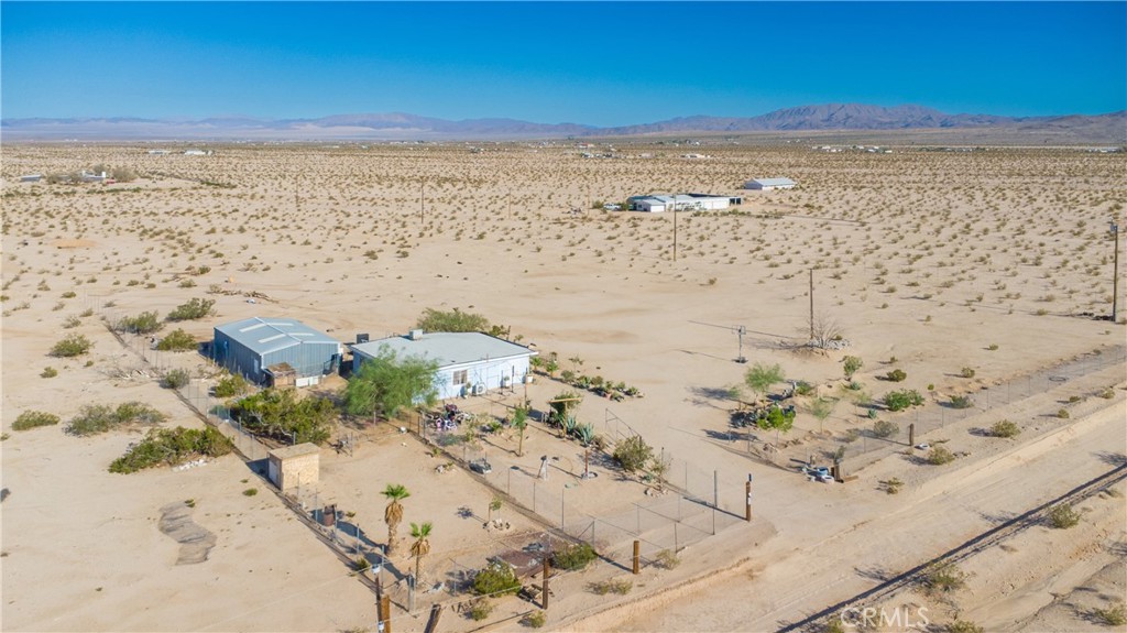 **Desert Retreat on 5 Acres – Peace, Privacy & Endless Potential**
Welcome to your serene escape in Wonder Valley! Nestled on 5 expansive acres in a quiet and peaceful neighborhood, this charming 3-bedroom, 1-bathroom home offers space, privacy, and the freedom to make it your own!
Step inside to find a cozy interior equipped with a modern mini-split AC system, ensuring year-round comfort. Outside, the property is dotted with mature trees and desert plants, creating a tranquil natural setting that's perfect for relaxing or entertaining.
A standout feature is the large workshop behind the home—ideal for artists, hobbyists, or anyone in need of extra space for projects or storage. With a private well, you'll enjoy sustainable living and reduced utility costs.
At night, gaze up and enjoy unobstructed views of the star-filled sky—a true desert luxury. Whether you're looking for a quiet residence, a vacation getaway, or a creative retreat, this property offers endless possibilities.
Don’t miss your chance to own a slice of the desert with room to breathe, build, and dream.