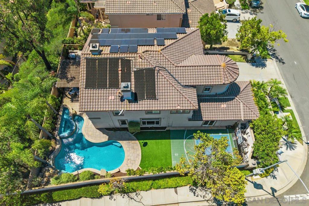 Elevate your lifestyle in the sought-after Carmel Country Highlands with this Belmont floor plan 3 home featuring a turret. Positioned on a corner elevated lot, it boasts an expansive side yard and privacy with neighbors only on one side. Over $300K in upgrades showcase quality and craftsmanship throughout, with a professionally reconfigured custom kitchen, rich hardwood floors, high ceilings, and crown moldings. Enjoy custom lighting, built-ins, shutters, custom closets, solar shades, formal living and dining rooms, and multiple fireplaces. The spa-like primary bathroom and a 3-car garage with epoxy flooring enhance this home's appeal. This energy-efficient property includes an owned solar system for both house and pool. It offers 5 bedrooms, 4 bathrooms, and a bonus/office space in the turret. A full bedroom and bath on the entry level are perfect for guests, in-laws, or a second office. Step outside to your private resort with a sparkling heated pool/spa, built-in BBQ, and basketball/sport court, designed for year-round enjoyment with seamless indoor-outdoor flow. Located within award-winning schools, including Sage Canyon Elementary, Carmel Valley Middle, and Torrey Pines High School, this home is minutes from the world-famous Grand Del Mar Resort, Addison (Michelin-starred restaurant), and Meadows golf course. Enjoy quick access to the beach, shopping, parks, restaurants, cafés, and major highways I5 and 56. This beautifully upgraded home, offering exceptional privacy, space, and style rarely found, is a must-see!