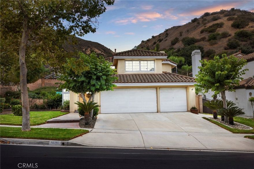 Welcome to 1680 San Almada Rd! Located in the in the highly sought after community of Sierra Del Oro in Corona, this 4-Bedroom 3-Bathroom sits on a picturesque 10,400 SqFt corner lot sitting along the foothills. As you walk in, you'll immediately notice the open floor plan concept allowing for natural light to flow endlessly throughout the high-ceilinged home. The updated flooring found in the main parts of the residence seamlessly compliments the contemporary appeal this unique home has to offer. As you step into the kitchen, aside from the spacious kitchen island, you'll realize the various windows that allow light and tranquil views into the backyard garden. A convenient downstairs Bedroom is located next to a full Bathroom with a walk-in shower, --perfect for overnight guests or multigenerational living. Upstairs, the Primary Ensuite Bedroom is a true gem, showcasing cathedral ceilings, garden views, an area used as an office space, and a large walk-in closet. Two more spacious bedrooms are found down the hall adding a more private feel to the ensuite master. Outside, the backyard has the most peaceful garden feel allowing for endless opportunities that surrounding retaining walls provide. Arrange an appointment to view this home today!