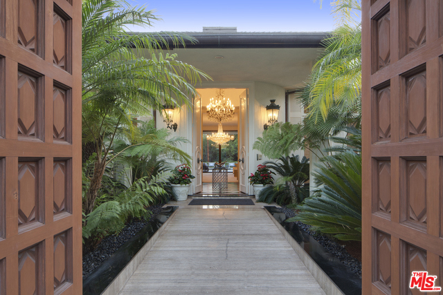 Set behind wrought iron gates atop a long private drive in prestigious Holmby Hills, rests a majestic French Regency Estate by renowned architect, Caspar Ehmcke. Best known for his indoor-outdoor feel, Ehmcke's simple lines & open living space typify his style. Situated at the end of Holmby Park on 1.2 acres of lush green gardens this estate features picturesque views of the Los Angeles Country Club & the Century City skyline. The 9,200 square foot main residence includes 5 bdms/5.5 bathrms. The home includes a dramatic foyer, classic interior, high ceilings throughout, a voluminous decadent living room, a breakfast solarium surrounded by circular walls of glass, two spacious master bedrooms with breathtaking marble slated bathrooms and a post-modern kitchen. Amenities include: Outdoor oasis with spacious pool deck and patio, expansive pool, cabana, two-story guest house, 3 car garage and motor court. This is a gorgeous estate in an unrivaled setting and a once in a lifetime offering.