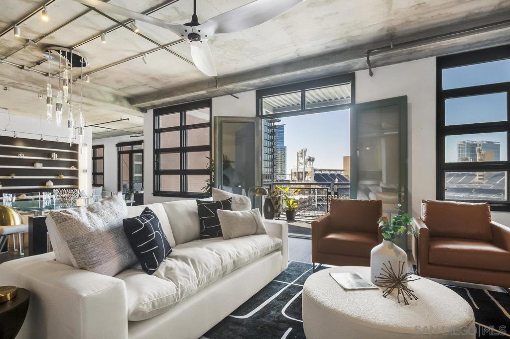 Just one block from Petco Park in the heart of East Village, this stunning 2-bedroom, 2.5-bath loft-style residence with unparalleled ballpark views offers 2,325 square feet of open-concept living with a rare blend of industrial style and modern luxury. With direct views into the ballpark from two private balconies, you can catch the action and feel the energy of the game right from your home. This unique loft features soaring ceilings, floor-to-ceiling windows, and one enclosed bedroom for added privacy. Two oversized walk-in closets provide ample storage, while two side-by-side parking spots and a separate storage locker add unmatched convenience. Parkloft offers premier amenities including 24-hour front desk service, on-site property manager, dedicated security, a modern fitness center, stylish communal gathering space, and impeccably maintained common areas. Live where the city pulses with excitement—steps from dining, nightlife, culture, and everything the downtown San Diego lifestyle has to offer. Don't miss this opportunity to own one of the most dynamic lofts in East Village.