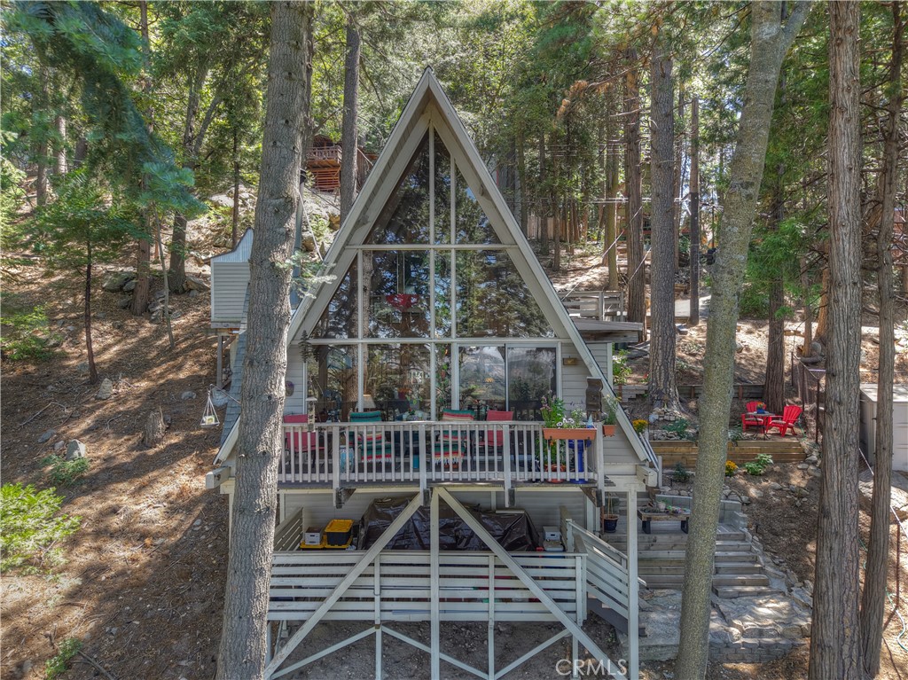 Discover this delightfully appointed A-Frame cabin that captures the essence of mountain living. From the moment you step onto the nature-kissed entry porch, this home welcomes you into a serene escape.
Main Level Highlights:
Soaring A-Frame ceilings create an airy, inviting atmosphere—both cozy and charming.
Bedroom 1, full bathroom, kitchen, dining area, and living room with wood-burning fireplace offer functional elegance.
Glass sliders open to a private deck surrounded by trees—perfect for morning coffee or watching valley lights twinkle below at dusk.
Upper Loft:
Bedroom 2 is tucked into the loft, offering intimate sleeping quarters rich in charm and character.
Space for a desk with a view makes this a peaceful creative retreat.
Outdoor Perks:
A shed near your 3-car parking area adds practical storage for mountain gear and seasonal items.
Lower level features laundry, additional storage, and an oversized deck with expansion potential.
Location, Location, Location!
Just minutes from uptown Crestline, Lake Gregory, and downtown Crestline, with easy drive to:
SkyPark at Santa’s Village,
Lake Arrowhead Village,
Snow Valley ski resort.
All just a short 30-minute commute down the hill—ideal for full-time living, weekend escapes, or investment potential.
A must-see for the A-Frame enthusiast.