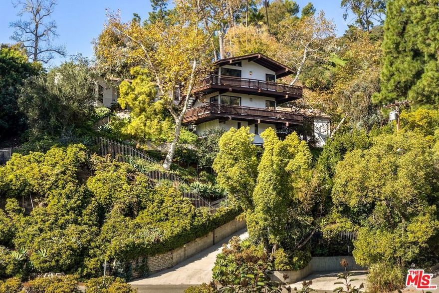 The Natzler Residence is offered for the first time in 80 years. This 1937 home in Upper Nichols Canyon served as both sanctuary and working studio for Gertrud and Otto Natzler, among the most important ceramicists of the 20th century. In light-filled rooms overlooking treetops and canyons, Gertrud threw delicate forms on the wheel they brought from Austria while Otto developed the groundbreaking glazes that defined their partnership.The main residence includes two bedrooms and two and one-half baths, a living room with fireplace, dining room, and a kitchen with ceramic tiles glazed by Otto Natzler. In 1988, Otto commissioned a two-story addition inspired by his Austrian roots  a contemporary nod to an Alpine chalet  designed by architect Alfred T. Wilkes, AIA, for photographer Gail Reynolds Natzler, his second wife after Gertrud's passing in 1971. The addition introduced a studio and darkroom below and a vaulted primary suite above, both with wraparound balconies and canyon views.The detached Natzler ceramic studio suite above the garage includes a kitchen, small bedroom, and bath. The property abuts the Briar Summit Open Space Reserve, ensuring lasting privacy and an enduring connection to nature  a living reflection of the Natzlers' creative legacy.