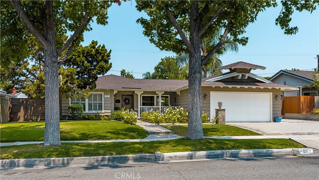 Modern comfort meets timeless charm in this beautifully renovated three-bedroom, two-bath home on a tree-lined street in a very desirable North Orange neighborhood. Inside, an open floor plan centers around a stylish, upgraded kitchen with quartz countertops, double oven, 6-burner cooktop, farm sink, built-in wine refrigerator, and a spacious island—perfect for gatherings and casual dining. A massive glass panoramic sliding door opens seamlessly to your private backyard oasis, where a sun-drenched patio and sparkling swimming pool await. Whether entertaining friends or enjoying a quiet evening under the stars, this home offers the ideal blend of indoor-outdoor Southern California living.
The front yard is professionally landscaped with California gold slate accents on the driveway, porch, and walkways, and a welcoming porch is perfect for morning coffee. Bamboo flooring in the bedrooms and luxury vinyl plank flooring in the living areas give the home a fresh, modern feel. Additional features include brand new exterior paint, a custom Dutch door, newer HVAC system, remodeled closets by California closets, ceiling fans, shaded brick patio, Tesla universal charging station, two-car attached garage with direct access, and extra parking for a small RV or additional vehicle.
Located near Eisenhower Park, shopping, dining, and in the sought-after Villa Park High School & Cerro Villa Junior High attendance boundaries, this move-in ready home is a true North Orange gem!