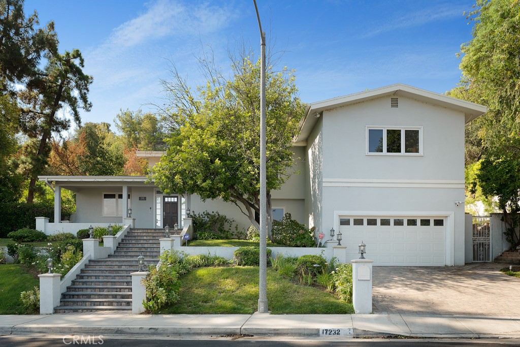 Welcome to this exquisite and charming residence situated in the prestigious Encino hills. This beautiful traditional home has been thoughtfully remodeled, showcasing meticulous attention to detail throughout. Upon entering, you'll be greeted by the timeless elegance of hardwood flooring. The kitchen has been tastefully upgraded with high-end, state-of-the-art appliances, exuding brightness and a welcoming ambiance. Granite countertops complement the elegant white washed cabinetry, creating a harmonious and sophisticated atmosphere. The bathrooms boast luxurious Walker Zanger tiles, adding a touch of opulence to the space. Natural light floods the interior through skylights, providing a warm and inviting feel to every room. The center hall floor plan offers ample space, featuring four bedrooms and three and a half bathrooms, ensuring comfort and privacy for all residents. The large yard is a private sanctuary, complete with a stacked stone pool and spa, perfect for relaxing and entertaining. Embrace the tranquility and timeless allure of this remarkable home in the heart of Encino hills, where traditional charm meets modern sophistication.