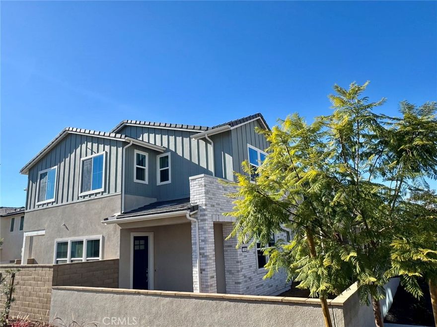 Welcome to this brand-new, beautifully upgraded home in the desirable Portia community at Great Park. Offering approximately 2,546 sq. ft., this two-story residence features an open floor plan with a gourmet kitchen showcasing quartz countertops, premium stainless-steel appliances, and a large center island flowing into the bright dining and living areas. A rare dual-staircase layout provides exceptional flexibility—one leads to the primary suite with walk-in closet and spa-inspired bath plus two bedrooms and a shared bath, while the second opens to a spacious loft, private bedroom, and full bath—perfect for guests or a home office. Additional highlights include a two-car attached garage, smart home features, leased solar panels, and in-unit washer and dryer. Enjoy access to Great Park’s resort-style amenities, including pools, parks, sports courts, and playgrounds.
