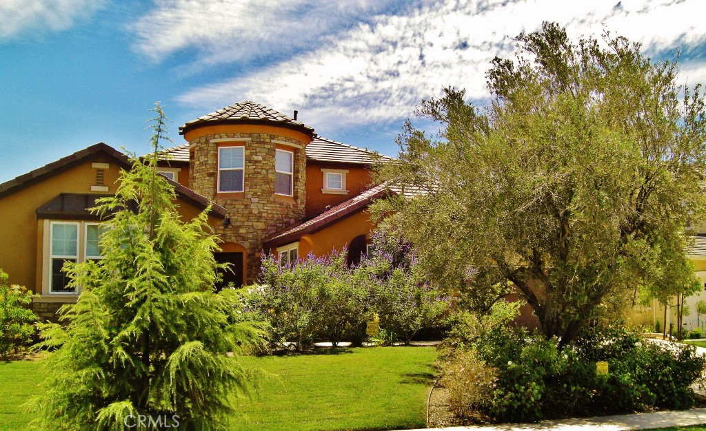 Custom BLU S.K.Y Home in Gated "City In The Hills Juliana’s Garden" community. This wonderful home features a TWO primary suites, one on each level with two additional bedrooms on the first floor. Significantly upgraded custom home with a custom designed natural stone front, on a very quiet semi-cul-de-sac street facing a park with a wonderful dream layout floor plan including two large suites, plus two other bedrooms with a park view in front bedroom. The entire 2nd floor is a large suite with a retreat and view completely private. Primary bath has an oval tub with fully tiled tub deck and sides, tiled primary shower with tiled floor. Frame less shower enclosure, bevel-edge mirror. Large walk-in closets in both suites. Two-tone interior paint. Juliana’s Garden Neighborhood Amenities Two Gated Entrances to Community Interior Mediterranean Garden With Fountains Interior Neighborhood Private Parks and Garden with Tot Lot Tree Lined Streets 6 minutes to markets and shopping 8 minutes to downtown Energy-efficient features include fiber-optic internet (up to 1000 Mbps), dual-glazed Low-E windows, dual-zone air conditioning, and a solar electric system by Sharp. All bedrooms are equipped with lighted ceiling fans and remote controls, outdoor lighting is on a timer, and there’s a gas BBQ hookup in the backyard. Additional upgrades include 220V outlet in the garage with and multiple GFI outlets, garage door opener with remote, and automatic front and backyard sprinklers. Interior highlights include 9-foot ceilings with 8-foot doors, oversized 5” baseboards, a large family room with formal dining area, and a welcoming entryway with tile flooring. Window treatments throughout the home include shutters, drapes, blinds, and Roman shades. The gourmet kitchen features stainless steel appliances, granite countertops with bullnose edges, upgraded Beachwood cabinetry, and a spacious nook with French doors leading to the backyard. Bathrooms include oil-rubbed Venetian bronze faucets and matching fixtures, and all door and light hardware is finished in complementary dark bronze tones.
