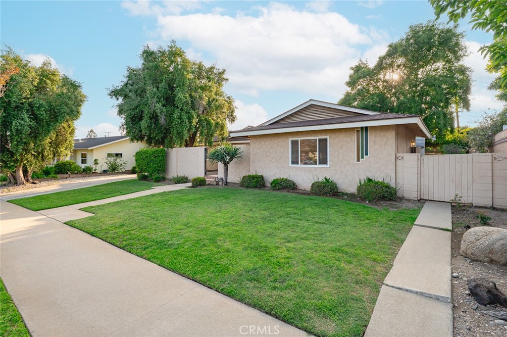Welcome to this beautifully renovated single-story ranch-style home nestled in one of Glendora’s most desirable neighborhoods. Located on a peaceful street just minutes from top-rated schools and Glendora Village, this 4-bedroom, 2-bathroom residence offers a spacious and flexible layout perfect for modern family living.
Step inside to discover a bright and welcoming living room with a classic brick fireplace and large windows that flood the space with natural light. The thoughtfully designed floor plan includes a separate family room, ideal for movie nights, a playroom, or even a home office setup. A generous dining area flows seamlessly into the newer kitchen—complete with ample cabinetry, wrap-around counters, and a cozy breakfast nook.
Each of the four bedrooms offers comfort and privacy with plenty of closet space. The spacious laundry room includes a utility sink and built-in shelving, adding convenience to everyday tasks.
Outside, you’ll find a private front courtyard shaded by a mature olive tree—perfect for morning coffee or quiet evenings. The backyard is a blank canvas for entertaining or relaxing, featuring a large covered patio and lush lawn space. The detached two-car garage and gated driveway provide ample room for parking, storage, and outdoor toys.