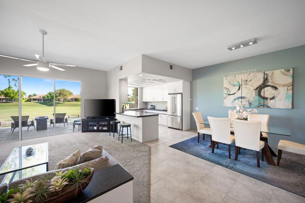 OPEN HOUSE -Sat, Sept 20th 11:00-2:00. Experience the Desert Lifestyle at its best in this impeccable home in guard-gated Mission Hills. With tasteful contemporary updates and decor, this stunning 1620 SF, 2 BR PLUS Den, 2 BA home is sold furnished. NO land lease-you own the land. Enter through a gated, inviting private courtyard, and enter the Great Room where you are greeted with expansive views of the 5th Fairway and Lake on the Westin Pete Dye Course. The Great Room has an open layout with the kitchen and dining room, perfect for family gatherings and entertaining. The light-filled, updated kitchen has large windows showcasing the amazing views. The cook of the family will love the stainless appliances, including gas range with double ovens. Abundant cabinets and quartz countertops offer ample workspace. Plus a separate pantry. Stunning dining room with contemporary chandelier gives a warm ambiance to gatherings. Great room sliders open to the updated, outdoor patio complete with propane table firepit. A great spot for entertaining, drinking your morning coffee or a cocktail in the evening enjoying the amazing golf course, mountain views and sunsets. Primary bedroom is large with ample closet space and has sliders that open to the private courtyard. Spacious, updated primary bath has a large shower and contemporary tile accents. Your guests will enjoy the cozy guest bedroom. The den offers a variety of uses and can accommodate a sleeper sofa. Sold furnished per Inventory List including outdoor furniture. All appliances have been updated along with A/C Heating, Tankless Gas Water Heater, and new Garage Doors. Home has a monitored security system and doorbell camera. 2 car garage, PLUS an additional golf cart stall. HOA covers the guard gated security, roof and exterior maintenance, common area grounds, cable, internet, trash and community pools and spas. Mission Hills CC memberships are available for social, sports activities and golf. The nearby Westin also offers social, sports & Golf Palm Club Memberships. Convenient location just minutes from Palm Springs Airport, Eisenhower Medical Center, Restaurants and El Paseo shopping. Great Opportunity to make this your Desert Retreat!