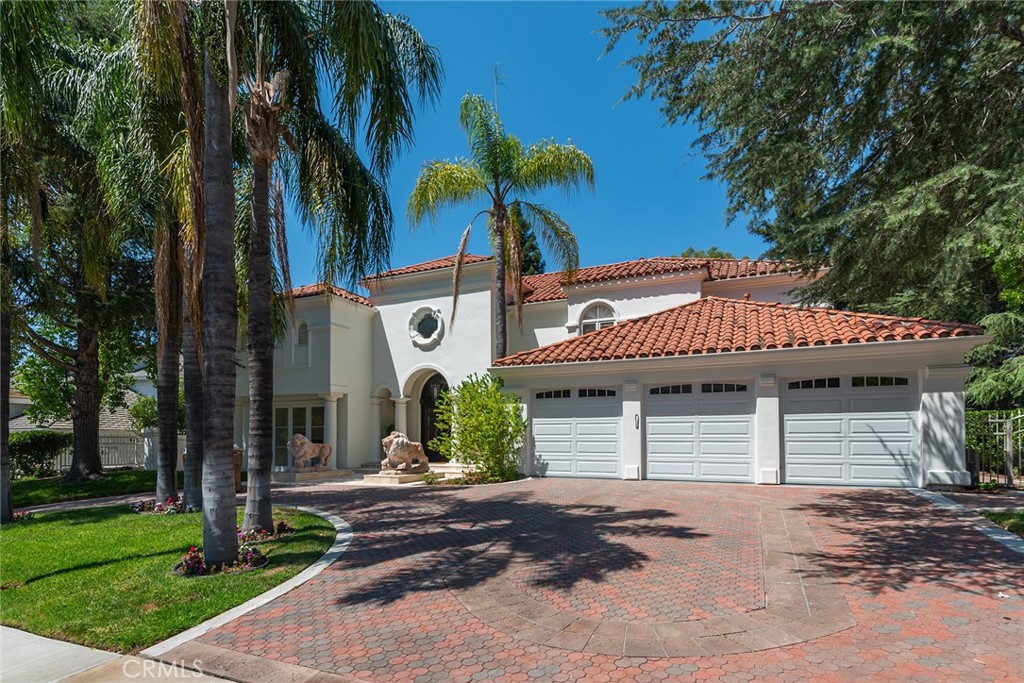 Located in the exclusive guard gated community of Mountain View Estates this furnished 6 bedroom 6 bathroom home offers 6158 sq ft of attractive living space on a corner lot with a circular driveway on a cul-de-sac street. The dramatic 2 story entry features marble floors, crystal chandelier and sweeping wooden staircase. Immediately upon entering you are drawn to a beautiful formal dining room with a crystal chandelier and a wall of windows/doors showcasing the lush backyard and pool. The oversized family room offers built-in cabinets, fireplace, sunken wet bar and hardwood floors. The generous size kitchen has white cabinets, granite countertops, center island, walk-in pantry, marble floors and a large breakfast room. The formal living room boasts a fireplace, gleaming crystal chandelier and marble floors. There is a bedroom suite downstairs with a large bathroom that can also serve as a pool bath with a door to the outside. Upstairs there are 5 bedrooms, all with hardwood floors. The primary suite has a gym area, balcony, fireplace, 2 walk-in closets, and a grand bathroom with dual vanities, spa tub, large shower, and a bidet. The inviting backyard features a large covered patio, pool, spa, and grassy lawns. This beautiful property is being leased furnished short term for 3-6 months. Located in the award winning Las Virgenes school district and convenient to shopping, fine dining, and a short drive to Pepperdine University and the beaches of Malibu.