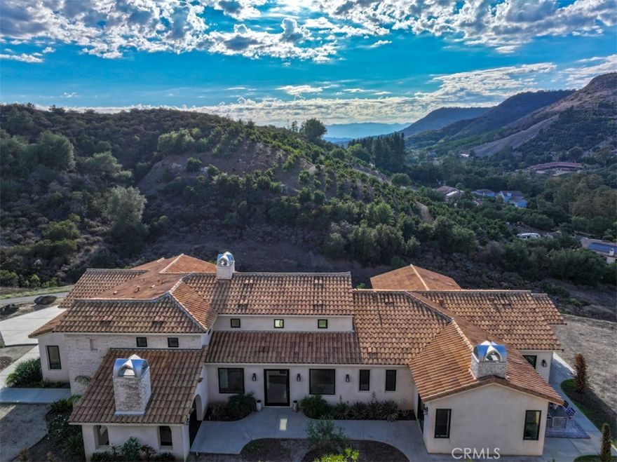 Absolutely Stunning Blend of Andalusian and Modern Architecture! Welcome Home! Unique Blend of Enchanting Tradition and Elegant Contemporary Comforts will Surely Captivate Your Senses. This Timeless Beauty is Perched above De Luz Road, Offering Breathtaking Panoramic Views of the Surrounding Landscape from Almost Every Window and Every Patio. Must See this Modern Minimalist Design; Offering a Refreshing and Distinctive Character and a Perfect Spot for Relaxation and Entertaining. High-End Features Include Leicht Custom Kitchen, Three Heat & Glo Linear Fireplaces, 10 Foot Ceilings Throughout and 17 Foot Ceilings in Foyer and Gathering Room, Surround Sound Entertainment System with 75"Sony OLED with Apple TV in Family Room, Statuario Italian Porcelain in Kitchen and Baths, 30x30 Italian Tile Throughout, Glass Enclosed Wine Cellar, Miele M Touch Appliances, Miele Six Burner Gas Stove with Electric Oven, Dishwasher, Steam Oven and Espresso/Coffee, Light Touch Built-in Refrigerator/Freezer, Axor "Shower Heaven" in Primary Suite, California Closets Vertuoso Collection, Axor Faucets, Duravit Sinks and Wall Hung Toilets Throughout (In-wall units by Toto), All Interior Wall Insulated for energy efficiency and noise reduction,  2x6 Construction exterior and interior walls, Large Capacity Maytage Washer and Dryer, Two Navies Tankless Water Heaters, Two Seer 17 Cooling Systems with EcoBee Smart Thermostats, Outdoor Security Cameras and So Much More! Large Backyard is Ready for Your Ideas and Design and Over Eight Acres of Land is Ready for your Green Thumb! Just Minutes from Historic Old Town Temecula (EST. 1859) and Temecula Wine Country, World Class Golf, Casinos, Shopping, Dining and Excellent Schools. Must See!