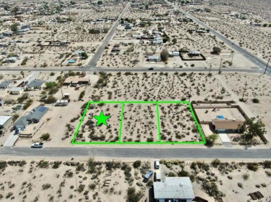 Owner may carry! Turn Key lot with utilities and paved road. 11,100 square foot (quarter acre) lot the trendy Hanson Area neighborhood in 29 Palms! Ideal for a developer or long term investor. The Hanson Area is known for its views. Set on a gentle incline offering northern vistas of the Bullion Mtns. To the west are the boulder studded Little San Bernardino Mtns with Joshua Peak. To the east are the Twentynine Palms Mtns. Quiet neighborhood. Close to the 29 Palms Restaurant and Inn, Theatre 29, and the Tortoise Rock Casino. Just down the road is the 29 Palms gate to the Joshua Tree National Monument. About 3 million tourists visit the park annually. Great vacation area. A few miles to the north is downtown 29 Palms with the new Freedom Mall and all amenities. Celebrities, artists and musicians are now calling 29 Palms home more than ever before. Would be great for a designer modern home or go with a prefab manufactured. Buyer must contact the city for all questions on building and usage. Buyers must contact the utilities agencies for all questions on utilities. APN: 0624-012-19-0000 Address is not a real address and for marketing purposes only. GPS: 34.122216, -116.035104 Don't Wait! Call Now! Additional parcels also for sale APNs: 0624-012-18-0000 & 0624-012-17-0000