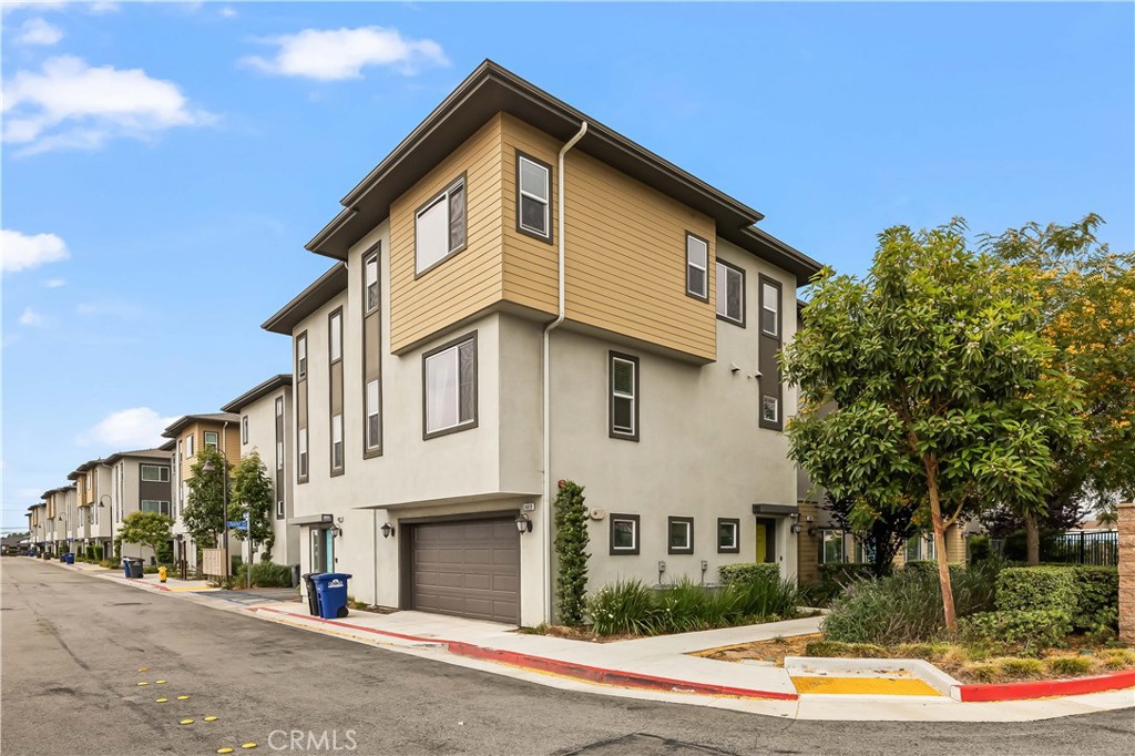 Welcome to this bright and modern tri-level townhome located in the Cottages at Harbor Pointe, a gated community just east of Torrance. This 2 bedroom, 2.5 bath tri-level townhouse is a nice corner unit with views of the city. The second floor features an open and airy floor plan with living room, dining area, and kitchen which features a large island with granite countertops great for entertaining. The kitchen also offers lots of cabinetry and a walk-in pantry. There is a half bath located on the second floor. On the third floor, escape to your serene primary bedroom with en-suite bathroom, unobstructed city views, a walk-in closet, and high ceiling. The second bedroom also has an en-suite bathroom, ideal for a home office, child’s room or guest suite. Also on the third floor is a stackable laundry in the hallway. There are Energy efficient features throughout the home which includes a tankless water heater, zoned thermostat for AC for your comfort, central heat and LED lighting. There is direct access to a large two-car garage. The community has a playground, picnic area with barbecue grills great for family gatherings, a dog park and large grassy area. This home is close to shops, parks, major freeways and all the best of the South Bay. Schedule a showing today and make this your new home.