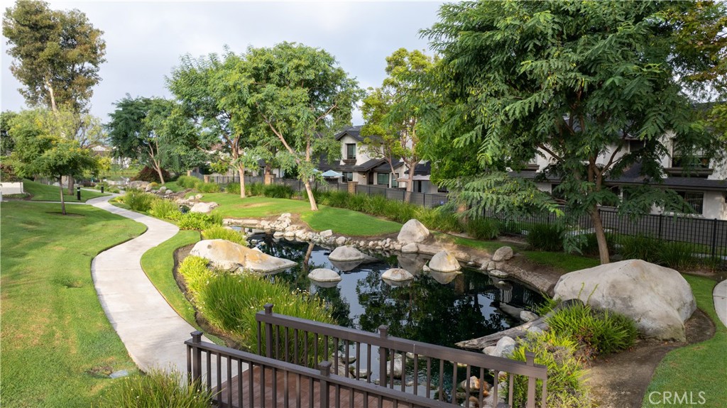 Charming Two-Level home offering 2-Bedrooms, 1.5 bathrooms with direct garage access. This beautifully maintained Lakeview Townhouse unit is nestled near the serene and sought-after Anaheim Shores neighborhood. Serene views unfold before you, with a gentle stream winding through the landscape and mature trees providing a lush green canopy. Enjoy your morning coffee on your lush private patio or unwind at the end of your day enjoying the premium views. The open layout is perfect for first-time buyers, down-sizers or investors looking for a move-in-ready property. Step inside to discover a well appointed kitchen equipped with a stove, microwave, dishwasher and plenty of counter space with bar top seating. Washer and dryer hooks-ups are conveniently located in the attached 2 car garage. The downstairs powder room and under-stairway storage is appreciated. Enjoy the natural light pouring into your open living room and separate dining area. Retreat to the comfortably sized bedrooms with ample and full mirrored wardrobes. Centrally located in a desirable neighborhood, this home offers easy access to schools, parks, shopping and dining options. Whether you're looking to live in or invest, this condo offers comfort, value, and location all in one. Don't miss this opportunity. Your dream home awaits!