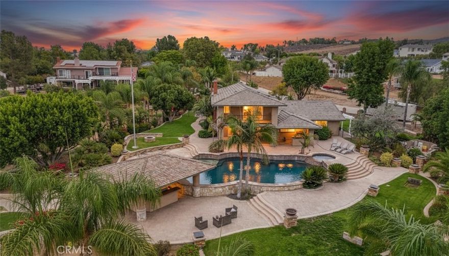 NOW LISTED WITH 2 PARCELS 2 Seperate Street Entrances 2.22 ACRES! NEW VIDEO!VERSATILE! PRIVATE, MOVE-IN READY! DOWNSTAIRS BEDROOM! NO MELLO ROOS & NO HOA! Property includes 2 contiguous parcels totaling approx. 2.22 acres(˜96,703 sq ft)each with its own driveway & private entrance & ideal for seamless pull-through access for trailers, RVs, & equipment. The steel workshop is approx 2,400 sq ft(40’ x 60’) Industrial roll-up doors,bathroom, Wheel Vehicle Lift, 2 Car Moveable Ramp Lift, Power Ready for High AMP welders; ect. Bring your boats, RVs trailers, trucks, & horses.Highlights:2 Driveways,Easy Maneuverability for Trucks,Trailers,RVs,& Boats. Horse property, Attached 3-car garage w/ direct access.Detached 2-car garage w/ a/c w/ ADU potential. Expand w/ included blueprints for future addition on the lower parcel & available to expand the main residence into a custom estate. Enter through the front doors & are welcomed by a stunning, custom-built 700+ gallon saltwater aquarium, true showpiece & it's architecturally designed, easy to maintain, tank & dedicated sump room located in the attached garage. Enjoy the life at the bar;  perfect space to relax &  enjoy the tranquil underwater show. The home features 4 bedrooms & 3 full bathrooms, including a downstairs bedroom & flexible dining area; both ideal for a home office, gym, or creative workspace. The open-concept kitchen & great room flow effortlessly through bi-fold sliding doors to the covered patio, pool, and spa. The primary suite includes a private balcony w/ views of the pool and breathtaking sunsets.The resort-style backyard includes a swim-up gazebo w/ professional-grade built-in smoker, flat-top grill, BBQ combo, kitchenette, Bluetooth sound system, outdoor speakers, in-water stools,ideal for relaxing,& hosting guests. Zoned HVAC w/ dual thermostats, solar panels, updated water heater & pool equipment, full security system w/ the cameras, septic, sump pump, & sprinkler system. The blueprints are designed to build an additional home on the 2nd parcel or transform the existing home into a luxury estate. Mature citrus & fruit trees approx 1500 fsq. ft. Recent inspections cleared: termite + septic. Schools, stores, hardware store, gas stations nearby. Move in before the holidays & make this extraordinary property your own. A rare estate combining beauty, privacy, and versatility,move-in ready yet designed to grow with your vision. Make this extraordinary Woodcrest property your home for the holidays.