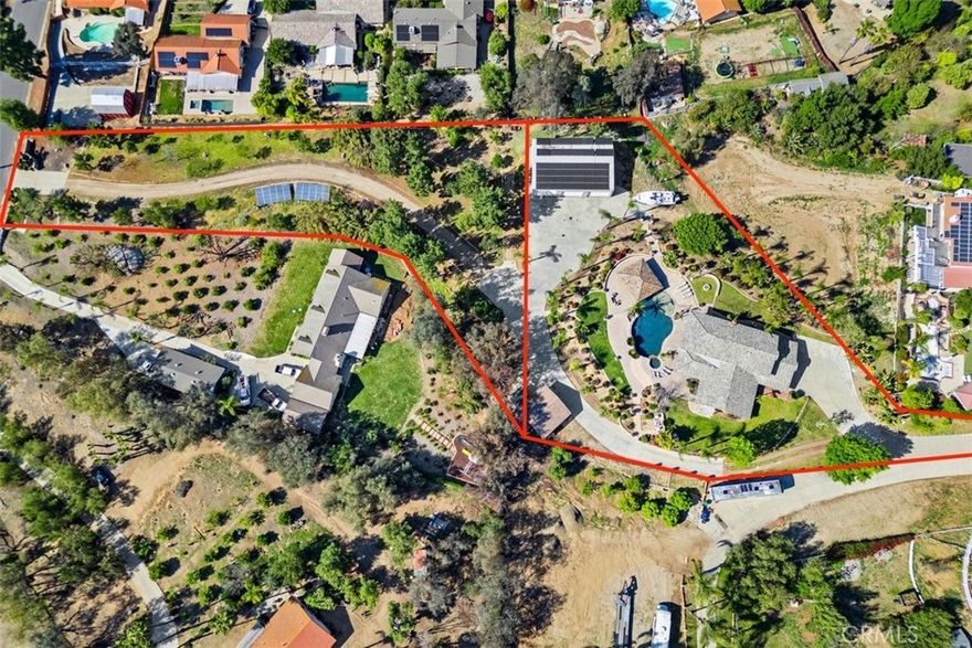 Woodcrest Community! ONE OF A KIND! 2.22 ACRES! PRIVATE,MOVE-IN READY! DOWNSTAIRS BEDROOM! NO MELLO ROOS & NO HOA! HORSE PROPERTY! Property includes 2 parcels connected totaling approx. 2.22 acres(˜96,703 sq ft)each with its own driveway & 2 private entrances & ideal for seamless pull-through access for trailers, RVs, & equipment. The steel workshop is approx 2,400 sq ft(40’ x 60’) Industrial roll-up doors,bathroom, Wheel Vehicle Lift, 2 Car Moveable Ramp Lift, Power Ready for High AMP welders; ect. Bring your boats, RVs trailers, trucks, & horses.Highlights:2 Driveways,Easy Maneuverability for Trucks,Trailers,RVs,& Boats. Horse property, Attached 3-car garage w/ direct access.Detached 2-car garage w/ a/c w/ ADU potential. Expand w/ included blueprints for future addition on the lower parcel & available to expand the main residence into a custom estate. Enter through the front doors & are welcomed by a stunning, custom-built 700+gallon saltwater aquarium, true showpiece & it's architecturally designed, easy to maintain, tank & dedicated sump room located in the attached garage. Enjoy the life at the bar;  perfect space to relax &  enjoy the tranquil underwater show. The home features 4 bedrooms & 3 full bathrooms, including a downstairs bedroom & flexible dining area; both ideal for a home office, gym, or creative workspace. The open-concept kitchen & great room flow effortlessly through bi-fold sliding doors to the covered patio, pool, and spa. The primary suite includes a private balcony w/ views of the pool and breathtaking sunsets.The resort-style backyard includes a swim-up gazebo w/ professional-grade built-in smoker, flat-top grill, BBQ combo, kitchenette, Bluetooth sound system, outdoor speakers, in-water stools,ideal for relaxing,& hosting guests. Zoned HVAC w/ dual thermostats, solar panels, updated water heater & pool equipment, full security system w/ the cameras, septic, sump pump, & sprinkler system. The blueprints are designed to build an additional home on the 2nd parcel or transform the existing home into a luxury estate. Mature citrus & fruit trees approx 1500 fsq. ft. Recent inspections cleared: termite + septic. Schools, stores, hardware store, gas stations nearby. Move in before the holidays & make this extraordinary property your own. A rare estate combining beauty, privacy, and versatility,move-in ready yet designed to grow with your vision. Make this extraordinary Woodcrest property your home for the holidays.