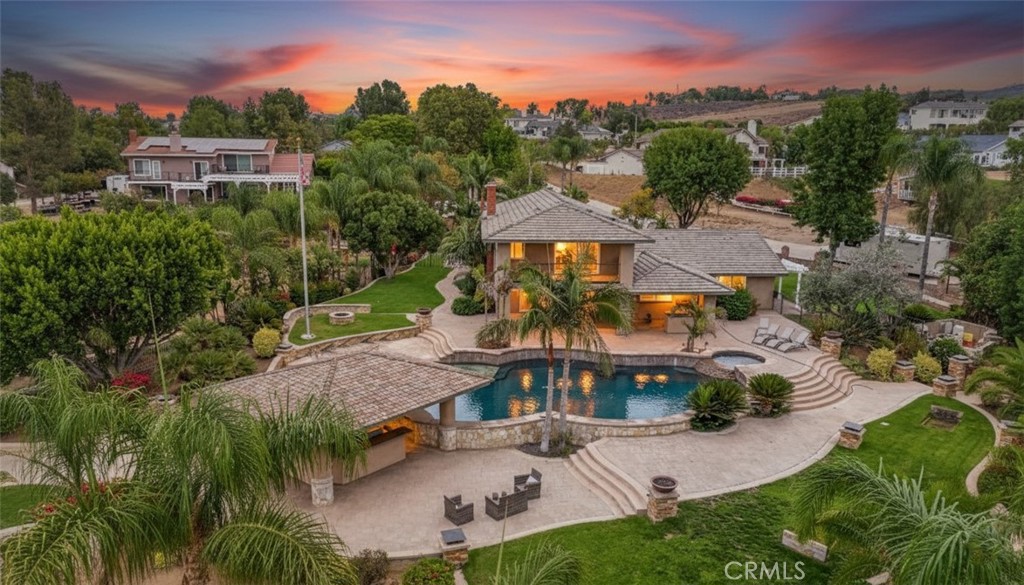 2 PARCELS totaling 2.22 ACRES! NEW VIDEO! 2 DRIVEWAYS VERSATILE, PRIVATE & MOVE-IN READY! DOWNSTAIRS BEDROOM! NO MELLO ROOS & NO HOA! Property includes 2 contiguous parcels totaling approx. 2.22 acres(˜96,703 sq ft)each with its own driveway & private entrance & ideal for seamless pull-through access for trailers, RVs, & equipment. The steel workshop is approx 2,400 sq ft(40’ x 60’) Industrial roll-up doors,bathroom, Wheel Vehicle Lift, 2 Car Moveable Ramp Lift, Power Ready for High AMP welders; ect. Bring your boats, RVs trailers, trucks, & horses.Highlights: 2 Driveways, Easy Maneuverability for trucks, trailers, RVs, and boats. Horse property, Attached 3-car garage w/ direct access. Detached 2-car garage w/ a/c w/ ADU potential. Expand w/ included blueprints for future addition on the lower parcel & available to expand the main residence into a custom estate. Enter through the front doors & are welcomed by a stunning, custom-built 700+ gallon saltwater aquarium, a true showpiece & it's architecturally designed, easy to maintain, tank includes dedicated sump room located in the attached garage. Enjoy the life at the bar; perfect space to relax & enjoy the tranquil underwater show. The home features 4 bedrooms & 3 full bathrooms, including a downstairs bedroom & flexible dining area; both ideal for a home office, gym, or creative workspace. The open-concept kitchen & great room flow effortlessly through bi-fold sliding doors to the covered patio, pool, and spa. The primary suite includes a private balcony w/ views of the pool and breathtaking sunsets.The resort-style backyard includes a swim-up gazebo w/ professional-grade built-in smoker, flat-top grill, BBQ combo, kitchenette, Bluetooth sound system, outdoor speakers, in-water stools,ideal for relaxing,& hosting guests. Zoned HVAC w/ dual thermostats, solar panels, updated water heater & pool equipment, full security system w/ the cameras, septic, sump pump, & sprinkler system. The blueprints are designed to build an additional home on the 2nd parcel or transform the existing home into a luxury estate. Mature citrus & fruit trees approx 1500 fsq. ft. Recent inspections cleared: termite + septic. Schools, stores, hardware store, gas stations nearby. Move in before the holidays & make this extraordinary property your own. A rare estate combining beauty, privacy, and versatility,move-in ready yet designed to grow with your vision. Make this extraordinary Woodcrest property your home for the holidays.