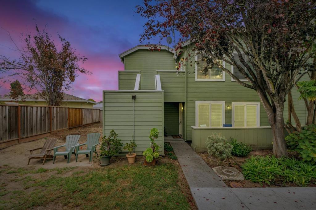 Units in this complex don't come up often, and this is one of the best! Quiet and tucked at the back of a small complex, this end unit has a large balcony off the primary bedroom and kitchen, perfect for enjoying the amazing Live Oak weather. A large and well-designed open living and kitchen layout provides ample room to personalize the space. A wood-burning fireplace is a unique treat; a half bath for guests, and an in-unit laundry area with storage, provide added simplicity. Freshly painted, new carpet, upgraded baseboards, and waterproof flooring in the bathrooms - this is ready for you to make it your own. Dedicated spot in covered carport. Enjoy all that Like Oak has to offer with the harbor, beaches, great surf spots, restaurants, shops, schools, the Simpkins Swim Center, weekly Farmer's Market, and grocery all within a short hop. With easy access to the Metro lines and biking trails, you can enjoy walkability and community in one of Santa Cruz County's most popular neighborhoods.