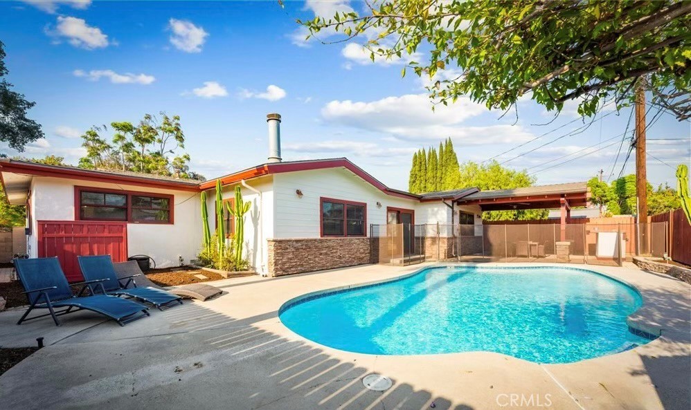 Beautiful Single-Story Pool Home in Desirable Anaheim Neighborhood. This stunning single-story home offers 2,008 sq. ft. of stylish, comfortable living in one of Anaheim’s most sought-after neighborhoods. With incredible curb appeal and a thoughtful layout, this property is perfect for everyday living and entertaining. The heart of the home is the spectacular modern kitchen, complete with custom craftsman-style cabinetry, granite countertops, a pull-up breakfast bar, and stainless steel appliances, including a high-end Thermador stove and built-in refrigerator/freezer. The kitchen flows seamlessly to a dining area with a cozy fireplace, recessed lighting, and backyard views. It also opens to a spacious family room that could easily be converted to a fourth bedroom if desired. This home features 3 bedrooms and 2.5 bathrooms, including a private primary suite with an en-suite bath. The additional bedrooms are generously sized and share a well-appointed hall bath, while a convenient powder room is perfect for guests. The backyard is your personal retreat, complete with a sparkling fenced pool, a covered patio with a ceiling fan, and a custom-built BBQ area, ideal for enjoying sunny California days. Additional features that enhance comfort and convenience include a tankless water heater, a central attic fan, and a two-car garage with direct home access. The home also boasts incredible curb appeal with new exterior paint, a freshly stained garage door, new front yard sod, and exterior stacked stone accents. Conveniently located near schools, parks, shopping, dining, and entertainment, this home offers the perfect balance of comfort, style, and location.
