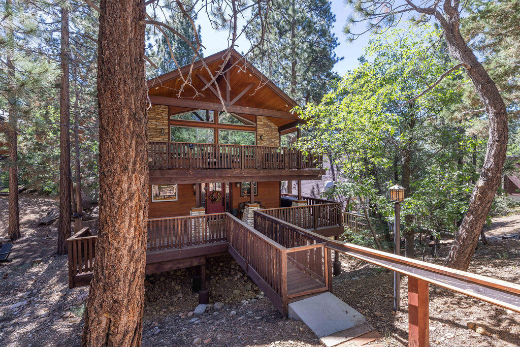 Located in the highly diesirable upper Sugarlof area, close to the national forest, this Stunning Craftsman-style home offers comfort, character and charm. The gourmet kitchen is outfitted with premium Viking stainless steel appliances, good for those who love to cook and entertain. A duel-sided fireplace adds warmth and ambiance to both the living room and kitchen, crating a cozy mountain vibe. Both spacious bedrooms feature their own fireplaces and cedar-lined closets, offering luxurious comfort year-round. Beautiful wood and tile floors run throughout the home, adding natural elegance to each space. Large windows flood the interior with natural light and provide peaceful views of the surrounding landscape, bringing the outdoors in. Built-in bookshelves and custom cabinerty offer convenient storage and classic character. The upstairs loft includes a wet bar and is wonderful for rlaxing, reading, pool, or hostings guests. Step ouside and unwind on the deck as you listen to the seasonal stream that flows, adding a soothing sountrack to your mountain escape. This property includes two lots totaling 7500 sq ft, providing extra space and privacy. Whether you're looking for a full-time residence, weekend retreat, or vacation rental opportunity, this home has it all ~ style, comfort and an unbeatable location. Dont miss this unique and inviting mountain getaway!