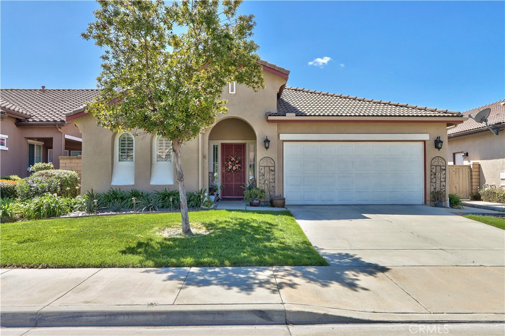 Welcome home to this turnkey beauty in the resort-style 55+ gated community of The OASIS. This elegant and distinguished Trento Floor Plan offers 2 bedrooms plus a large office/den. This home is one of the few homes in the community with desirable golf course and scenic lake views. As you step inside, you'll immediately notice the beautiful wide entryway, which leads to a spacious bedroom and full bathroom, along with a generously sized office/den featuring a beautiful double door entry. The entryway seamlessly opens into the heart of the home, revealing a large chef's kitchen and great room. This expansive living area is bathed in natural light and offers captivating views of your beautifully landscaped backyard and the tranquil lake. The large custom kitchen is a chef's delight, boasting a spacious center island with exquisite granite countertops, a stylish backsplash, custom cabinetry, and all stainless steel appliances. The kitchen thoughtfully flows into the great room and includes a large dining area, perfect for entertaining. The primary bedroom is a true sanctuary, featuring a large walk-in closet with organizers and a convenient slider that opens to the backyard, allowing you to wake up to picturesque views of your golf course surroundings. This home is replete with desirable features, including custom window shutters, ceiling fans throughout, large diagonal ceramic tile flooring and laminate flooring in the bedrooms, and custom lighting. The custom kitchen enhances the home's appeal. This home has been well maintained, exterior recently painted, a new tankless hot water heater and new A/C. The backyard is an absolute dream, offering breathtaking views of the lake and golf course, and providing the perfect setting for enjoying amazing sunsets. It's beautifully landscaped with a cement patio, an alumawood patio cover, and is bordered with a variety of colorful flowers and plants, creating a serene outdoor oasis. The oversized garage is designed to comfortably accommodate two cars and a golf cart, providing ample storage and convenience. The Oasis community itself offers an unparalleled lifestyle, with its convenient proximity to shopping, dining, medical facilities, and easy access to freeways. Residents can enjoy an array of amazing amenities, including a sprawling 22,000 sq. ft. clubhouse, a refreshing pool and spa, a well-equipped gym, tennis courts, and a vibrant calendar of events, and entertainment options. Low Tax and NO Mello Roos