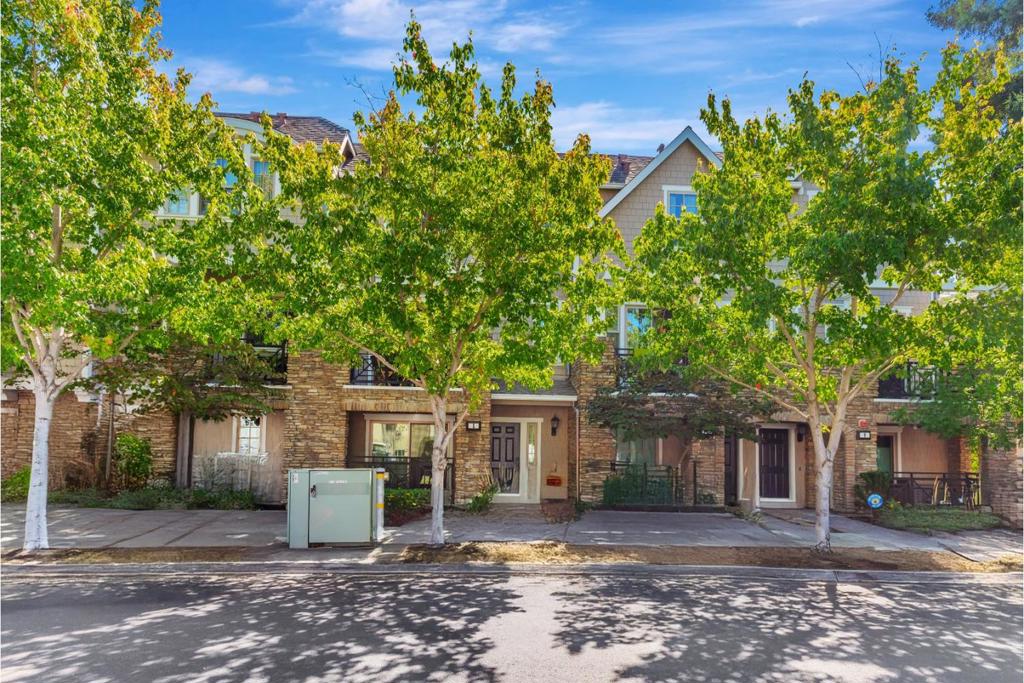 Beautiful Newer 3 Bed, 3.5 Bath Townhouse Near Downtown This beautiful townhouse is 0.5 miles from downtown Menlo Park and the Stanford Shopping Center. Even downtown Palo Alto is only about 0.75 miles away. An incredible number of cafes and shops are a short walk away. Nearby Nealon Park puts outdoor recreation a block away. If you like bicycling, nearby Sand Hill Rd is a favorite route to the Santa Cruz Mountains or to the Portola Valley - Woodside loop. The Allied Arts Guild hosts community events and numerous art studios and shops. Nearby Stanford University hosts numerous public events and you don't need a car to reach them, a bike or walking will be fine. This home has both a covered porch and a balcony where you can enjoy reading and refreshments outdoors. The modern kitchen has stainless steel appliances, light colored stone counter tops, high subway tile backsplash, rich stained wood cabinets and a wood plank floor, forming a delightful place to prepare meals. The kitchen is open to the dining room and to the living room beyond. It is a great floor plan for either daily family life or entertaining. All three bedrooms have their own bath en-suite. The bedroom on the ground floor could be a great guest room, an office, or a recreation room.