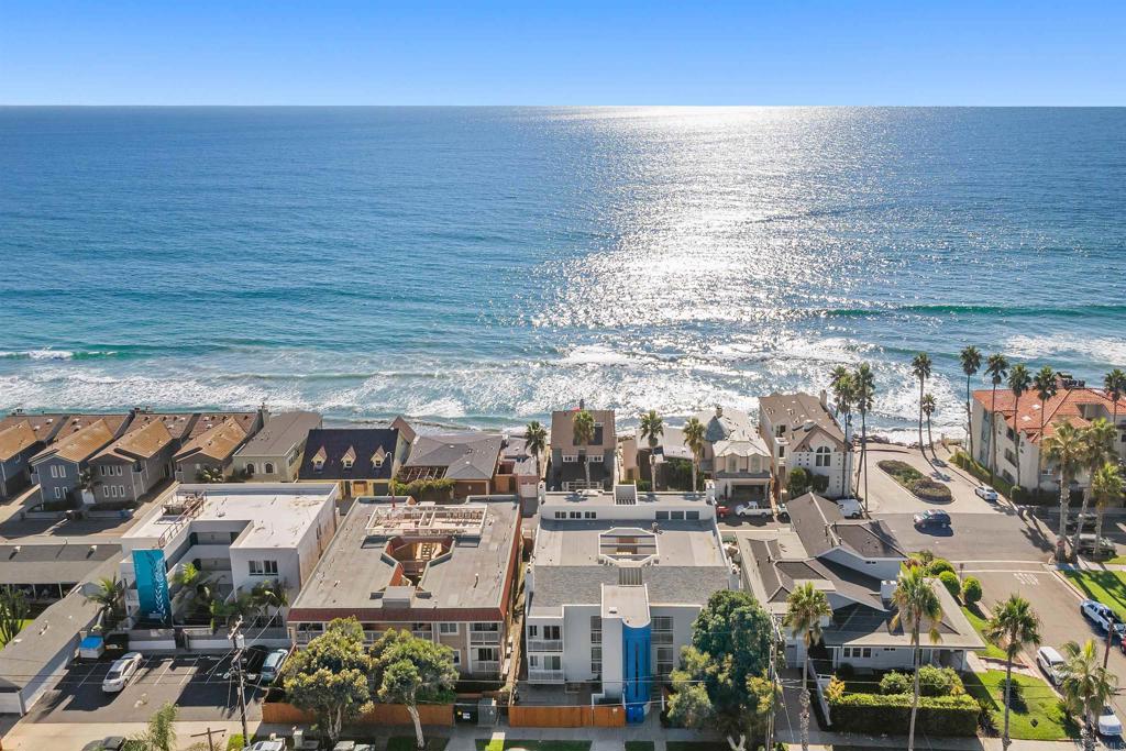 PRICED BELOW COMPS! Best value near the beach that is only 45 seconds to the water. Directly across the street from the beach but yet a private and quiet location-this unit is special. Upgraded kitchen & flooring. Panoramic ocean views from the complex areas which are only steps away-enjoy your morning coffee while watching the surfers and dolphins. This building is special and walking distance to shopping, parks, etc. Nice yard area to BBQ, lounge and enjoy. Gated parking structure with 2 spaces and 1 large storage closet below the building. Some units in the complex have converted this same type space to a 2br and added a 1/2 bath; lots of possibilities. This one has it all and the sunsets over the ocean are truly spectacular!