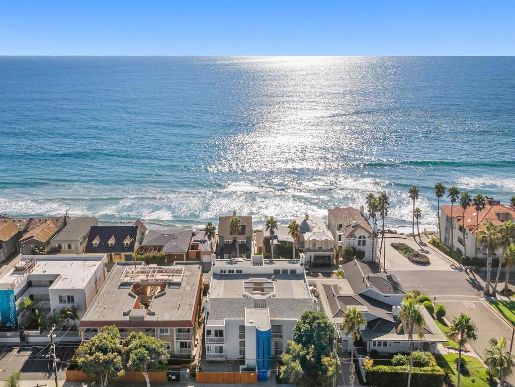 PRICED BELOW COMPS! Best value near the beach that is only 45 seconds to the water. Directly across the street from the beach but yet a private and quiet location-this unit is special. Upgraded kitchen & flooring. Panoramic ocean views from the complex areas which are only steps away-enjoy your morning coffee while watching the surfers and dolphins. This building is special and walking distance to shopping, parks, etc. Nice yard area to BBQ, lounge and enjoy. Gated parking structure with 2 spaces and 1 large storage closet below the building. Some units in the complex have converted this same type space to a 2br and added a 1/2 bath; lots of possibilities. This one has it all and the sunsets over the ocean are truly spectacular!