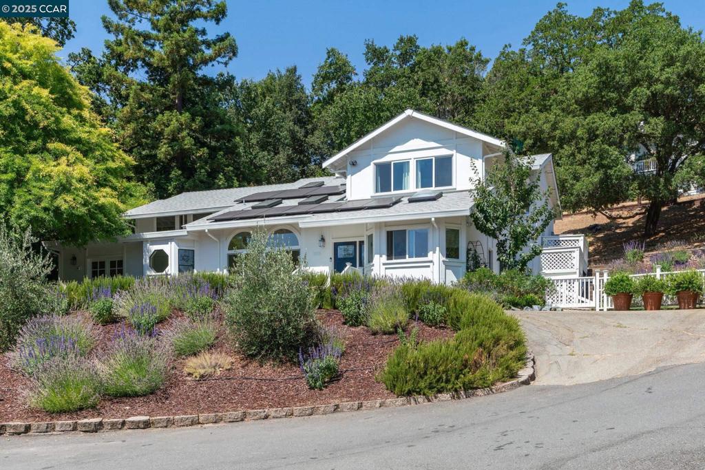 Nestled in a serene, family-friendly neighborhood, 3555 Old Mountain View Drive offers an exceptional 5-bedroom, 3-bathroom home with 3,082sqft of living space on a 0.44-acre lot. Located close to charming downtown Lafayette, this beautifully updated home is an entertainer's dream, featuring an expansive living room with soaring ceilings, skylights, and abundant natural light. The spacious layout includes 3 bedrooms and 2 bathrooms upstairs, and 2 bedrooms and 1 bathroom downstairs. Updated kitchen boasts sleek countertops, stainless steel appliances, wine fridge & instant hot water while the adjacent dining area flows seamlessly to the patio, BBQ area and level lawn. The airy primary suite offers hill views, high ceilings, and an updated bathroom with a luxurious soaking tub, shower and direct access to the rear patio and hot tub. Recent upgrades include a new roof, fully renovated bathrooms and laundry room, hot tub retreat and extensive drought-resistant landscaping updates w/irrigation. Neutral hardwood flooring and tile throughout with carpet in upstairs bedrooms. Equipped with smart thermostat. Enjoy year-round wildlife sightings, proximity to Lafayette Elementary, Stanley Middle School, and downtown dining and shopping. This home is a rare find in a prime location!