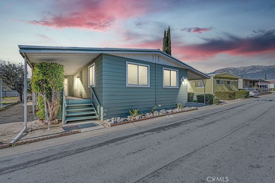 Welcome to The Pines! An inviting all-ages community in the heart of Rancho Cucamonga! This spacious 3 bedroom, 1.75 bath manufactured home offers 1,440 sq ft of comfortable living with a bright, open layout. Enjoy a large living area with a mix of laminate and carpet flooring, a functional kitchen with a gas range, and the convenience of inside laundry. The home sits on a rectangular lot and features a covered patio, perfect for relaxing outdoors. Additional highlights include central heating and air, two covered carport spaces, and a storage shed at the end of the driveway. Located between Archibald and Hermosa off Foothill, this home is situated in a well-kept community with great amenities, including a community pool, spa, and billiards room. The land lease is $1,325/month not including utilities. To be confirmed with park management.