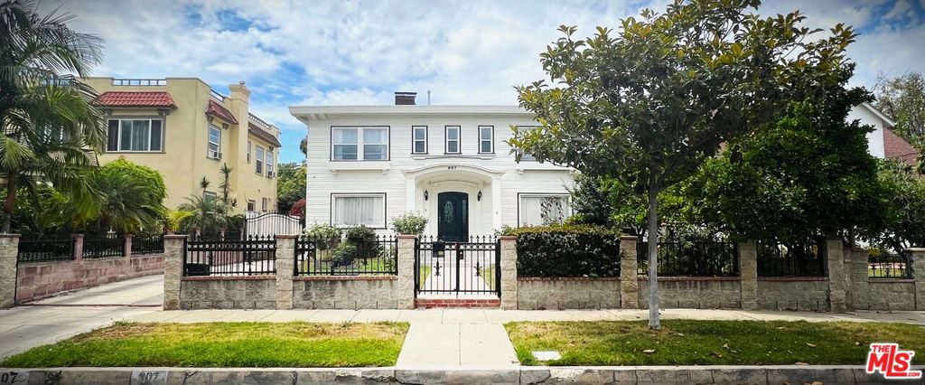 A location of this caliber is truly irreplaceable. Ideally situated on one of the most coveted, tree-lined streets in Wilshire Park HPOZ, 907 Westchester Place sits among a collection of architecturally significant homes that define this historic enclave. This Craftsman-influenced American Foursquare, enriched with Colonial Revival, faces east, welcoming the morning sun and bathing the interiors in abundant natural light throughout the day. The property has been taken down to the studs and thoughtfully rebuilt with a careful balance of preservation and modern refinement. The residence offers over 3,400 square feet of living space across 4 bedrooms and 4 bathrooms, featuring soaring ceilings, custom millwork, and interiors showered with natural light. The chef's kitchen pairs timeless white shaker cabinetry with marble countertops, creating a space that is both elegant and functional. Beyond, the expansive backyard unfolds into a private retreat with a basketball court, and generous space for a future pool or ADU. The detached garage is convenient to have and is ready for conversion into additional living space ideal for guests, a studio, or income-producing potential. Moments from Hancock Park, Koreatown, and the city's finest cultural destinations, this home offers the rare opportunity to own a masterfully restored piece of Los Angeles historyone that gracefully balances architectural heritage, modern living, and enduring value.