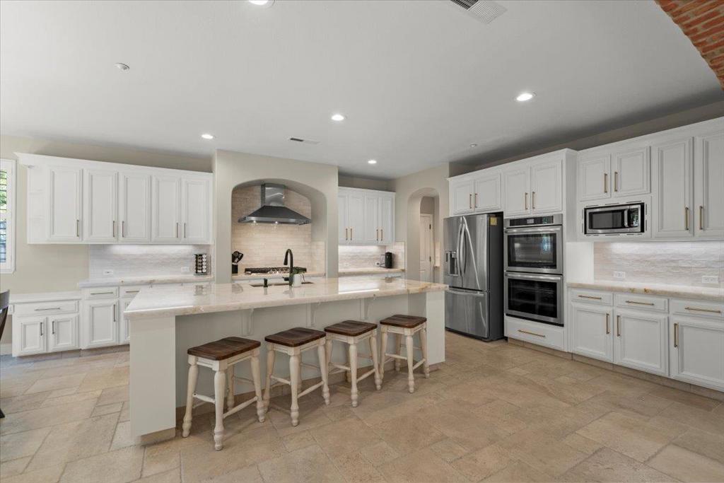 Gorgeously updated & maintained Eagle Ridge home on monster lot, in a prime location within the community. Newly reimagined designer kitchen with cristallo quartzite counters, zellige backsplash, and new high end stainless appliances. Located just down the street from Eagle Ridge's social hub, the main park, which features bocce courts, playground, park, junior olympic swimming pool, basketball courts, tennis courts, pickleball, and barbecuing area. Enjoy everything the residents of this gated community cherish; 24-7 security, an abundance of views of the foothills of the Santa Cruz Mountains, championship golf course, social clubs & sports, peace & quiet, and a profound sense of community. This home features an extended driveway, split 3-car garage, bed & bath downstairs, formal dining room, huge master bath with his & her closets, soaking tub, and large shower. Great room with oversized kitchen island, butler's pantry, and an abundance of counter space; perfect for family time or for entertaining friends & family. This beautifully manicured property has both pavers & grass in the back, with palm trees and lots of color, just amazingly peaceful & quiet. This property has it all, in a coveted community that residents absolutely love.