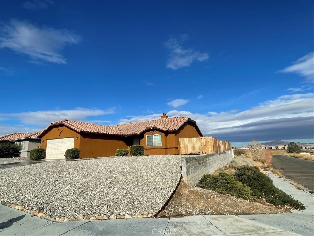 Spacious single-story home featuring 4 bedrooms and 2 bathrooms, including a master suite. Situated on a desirable corner lot, this property offers a functional and open layout designed for comfortable living. The home is turnkey and move-in ready, with a bright living area that seamlessly connects to the dining space and kitchen.Conveniently located near the freeway, shopping, dining, and schools, this home provides easy access to all that Victorville has to offer. Ideal for those seeking both comfort and convenience in a prime location.