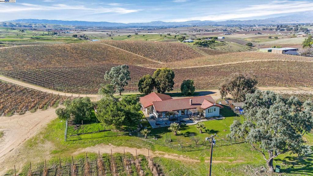 Premium 100 acre vineyard residence with abundant Ag and domestic water. Breathtaking views, multiple premium building sites. Many potential uses: 20 acre estate lots, winery, brewery, B & B, restaurant, equestrian use, and many others under A-CA Zoning. Continue the vineyard lease for income, cultivate the vines yourself, or change its use. The Madden Ranch is the most quintessential plot of land in the Livermore Valley. The contiguous 100 acres boasts commanding and awe inspiring views of the entire Tri-Valley. The gentle rolling hills lend the topography intrinsic character with multiple “view” building sites. Nestled adjacent to Poppy Hills Golf Course and among several other vineyards, wineries and equestrian facilities, it is ideally located for easy access to town and freeway. The more than 75 acres of award-winning vineyards were originally planted by Wente. Comprised of Cabernet Sauvignon (43 acres) and Sauvignon Blanc (32.39 acres), the Madden Corral (as it’s known) has been sought after fruit for many years, producing some of the finest wines by the best winemakers in the valley. Want a different variety? Just graft over the mature root stocks to something else. Secluded farm estate or development opportunity, the possibilities are endless. Live Well.