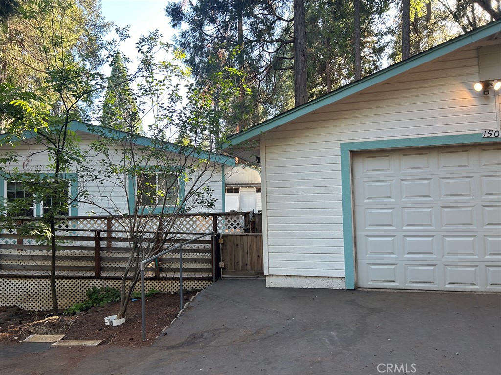 large manufactured home on a level, fenced lot. paved street with water and power. oversized garage and several shop buildings. extra large additional room.wooddecking all the way around home. in the forest with pine and oak trees. near lakes and fishing.